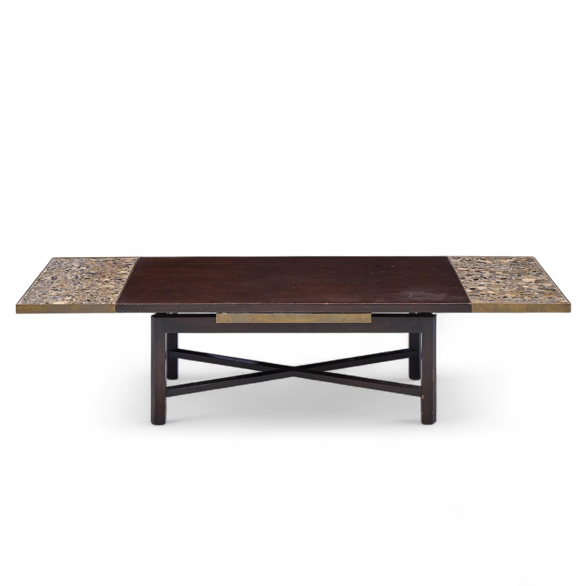 Edward Wormley for Dunbar Mid Century Walnut Stone and Brass Expanding Coffee Table

This expanding coffee table measures: 44 wide x 24.5 deep x 16.25 inches high. There are 2 expanding leaves that, when engaged, make a the table 68.5 inches