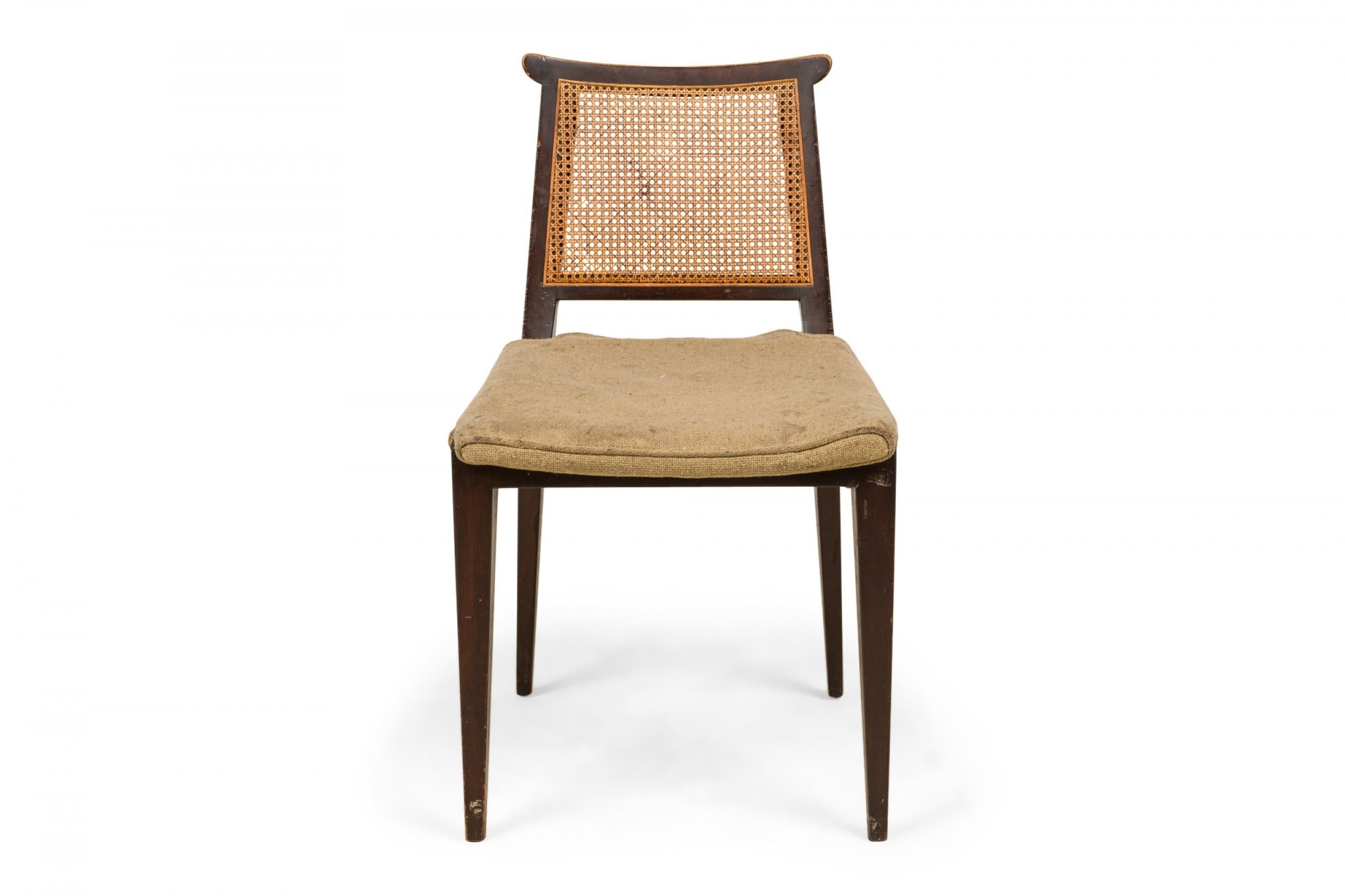 American Mid-Century side chair with a dark stained wooden frame, beige textured fabric upholstered seat, and caned back, resting on four tapered square legs. (EDWARD WORMLEY FOR DUNBAR FURNITURE COMPANY)

