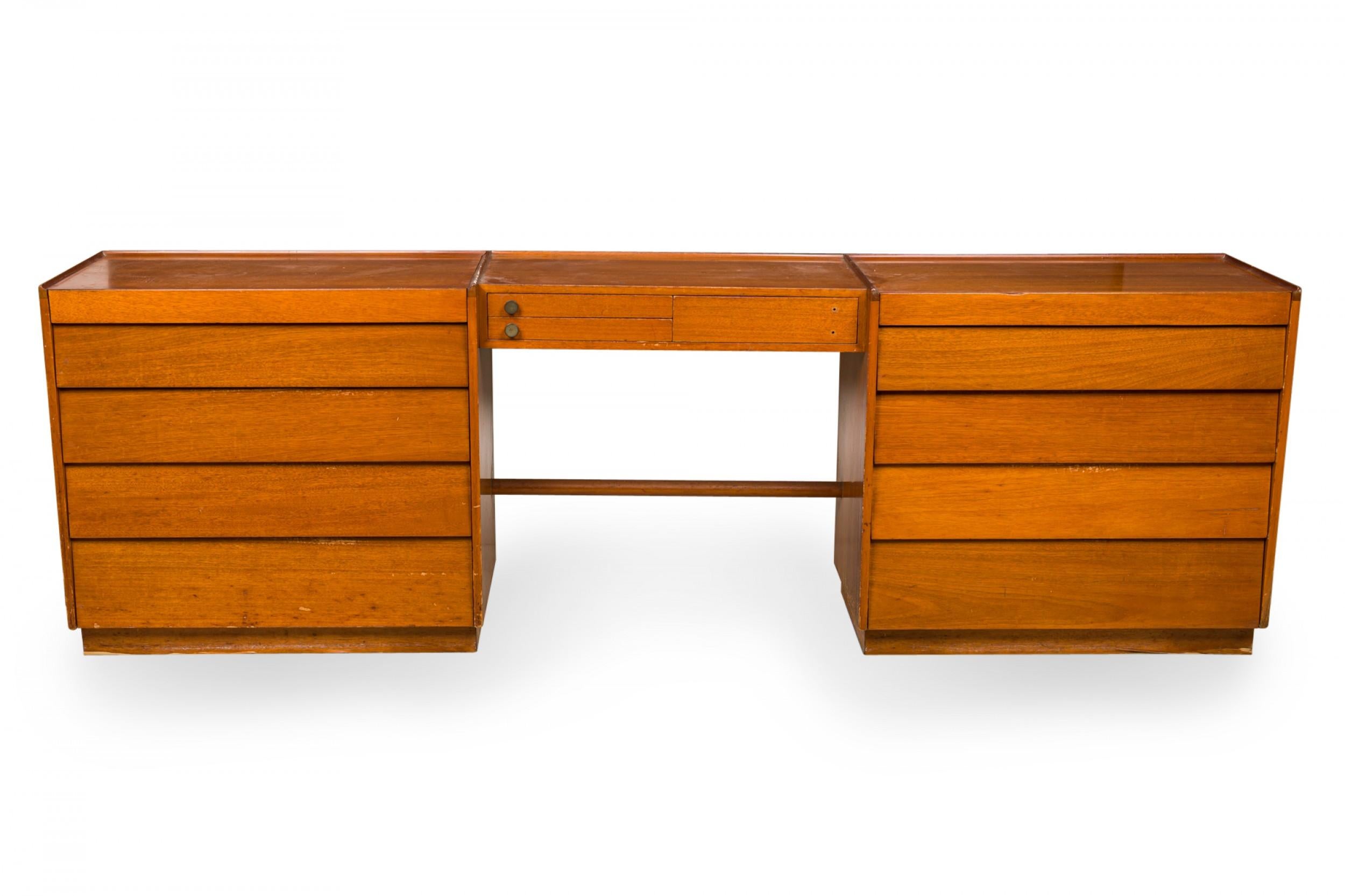 American mid-century wooden dressing table / vanity cabinet with two sections of drawers on either side of a knee hole opening. (EDWARD WORMLEY FOR DUNBAR)
