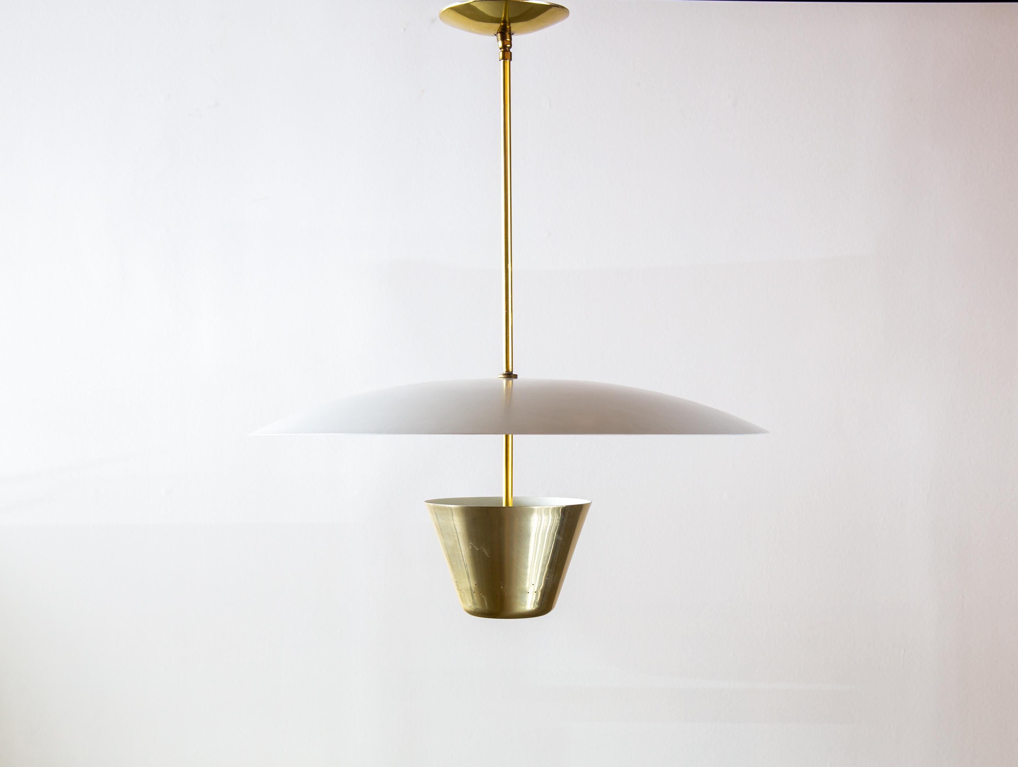 A simplistic form from Edward Wormley for lightolier.  The white cup allows for light to diffuse through perforations as well as directs light up which bounces and diffuses off the large shade to cast a nice soft light.  Seemingly floating in air as