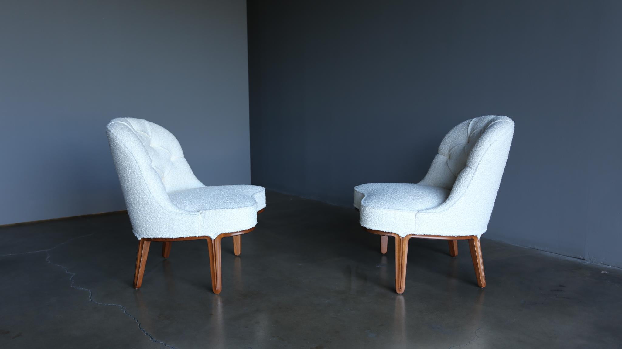 Edward Wormley Janus slipper lounge chairs for Dunbar, Circa 1955. This pair has been professionally restored in cream bouclé.
