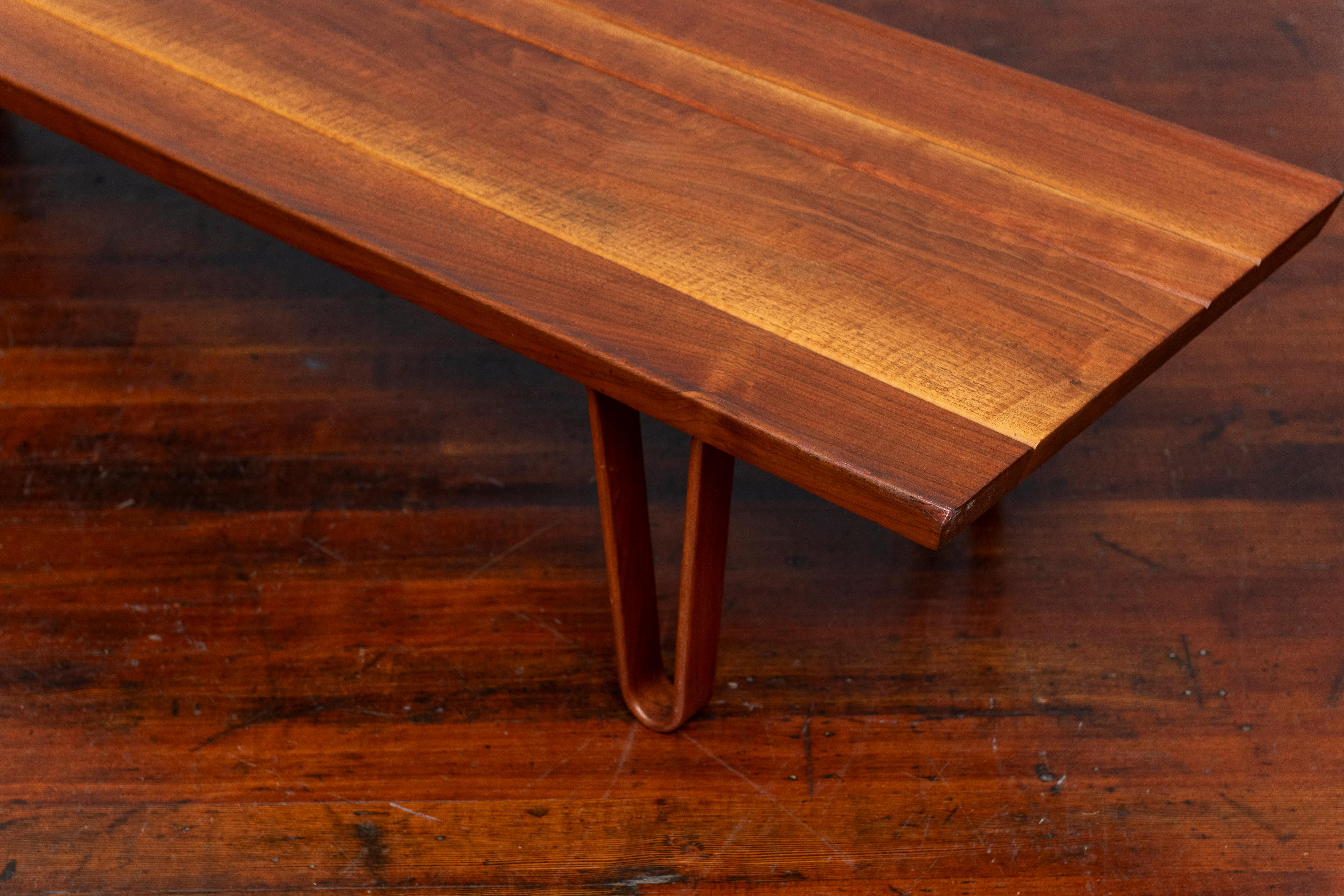 Edward Wormley design Long John Bench for Dunbar Furniture Company. Simple yet sophisticated design bench or coffee table that was an immediate sales success when launched. Made from solid walnut on molded wood hair pin legs, retains original tag.