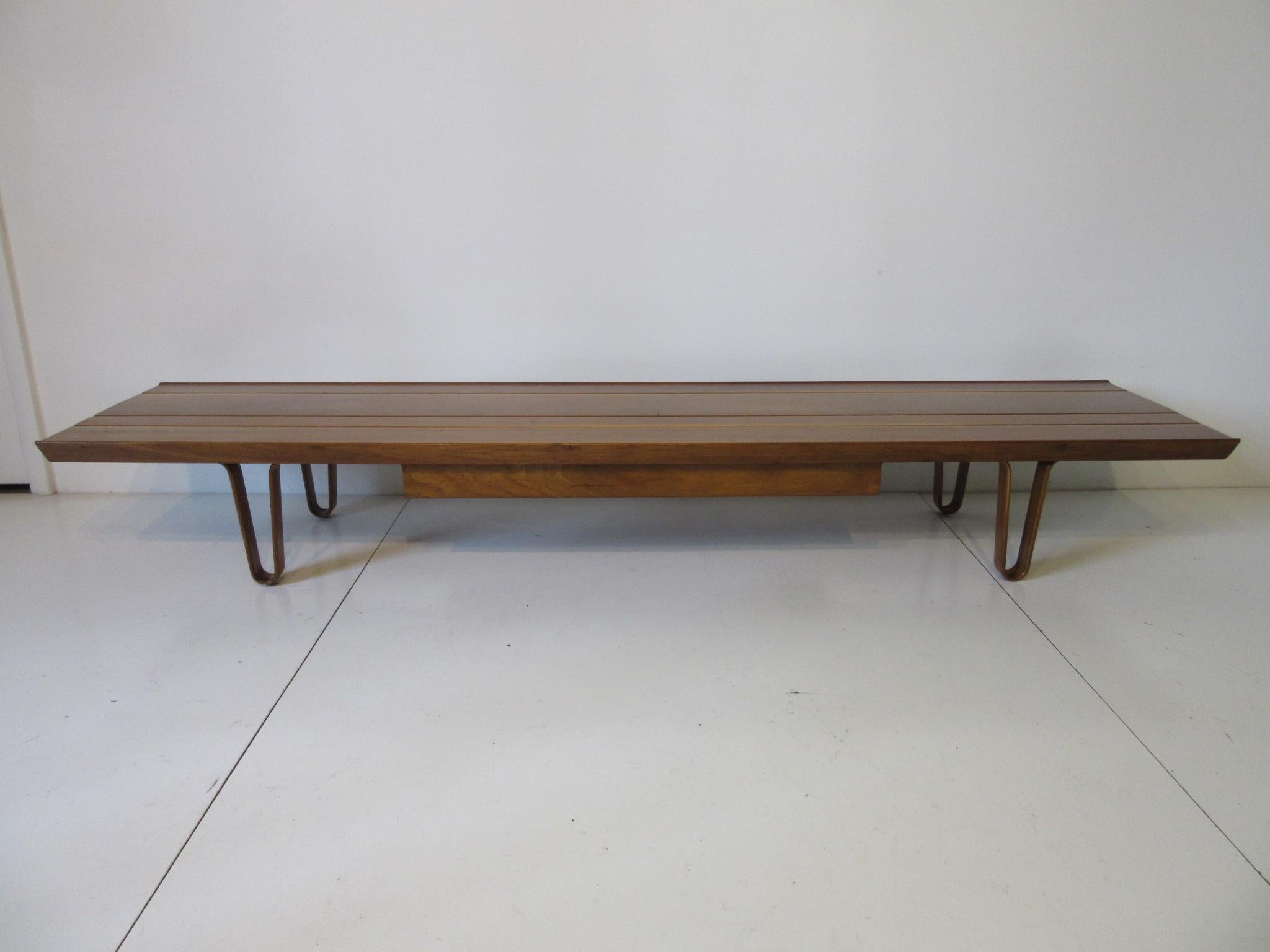 A well grained solid mahogany coffee table with matching wooden hairpin legs and a pull-out drawer one of Edward Wormley's best designs. Retains the gold tone metal tag manufactured by the Dunbar Furniture Company.