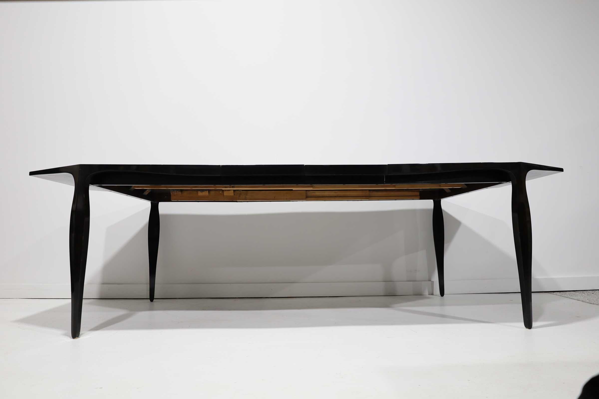 A beautiful example of Ed Wormley's refined aesthetic and Dunbar's quality construction, this dining table has a very pleasing mix of straight lines and elegant curves. The octagonal top has a skirt and legs with undulating lines. There is a banding