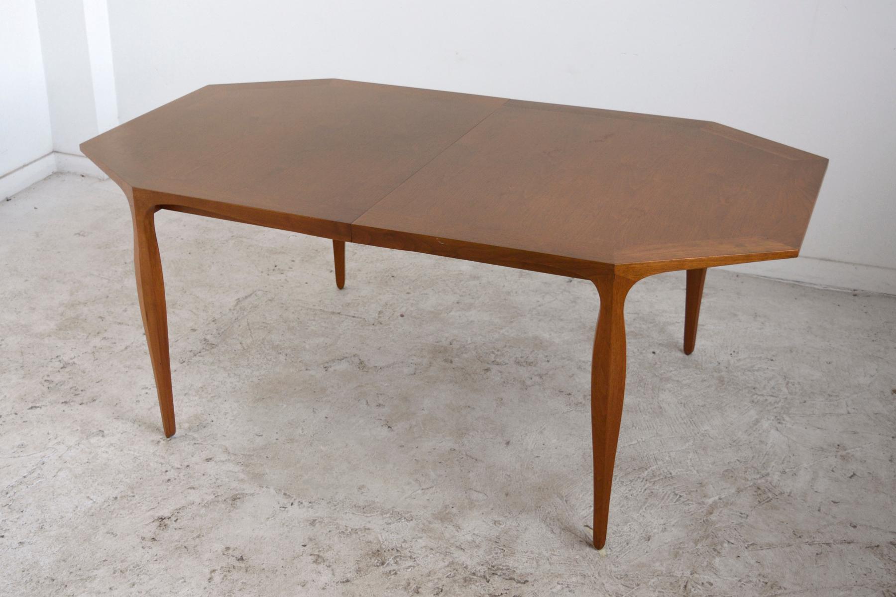 A beautiful example of Ed Wormley's refined aesthetic and Dunbar's quality construction, this dining table has a very pleasing mix of straight lines and elegant curves. The octagonal top has a skirt and legs with undulating lines. The top also has