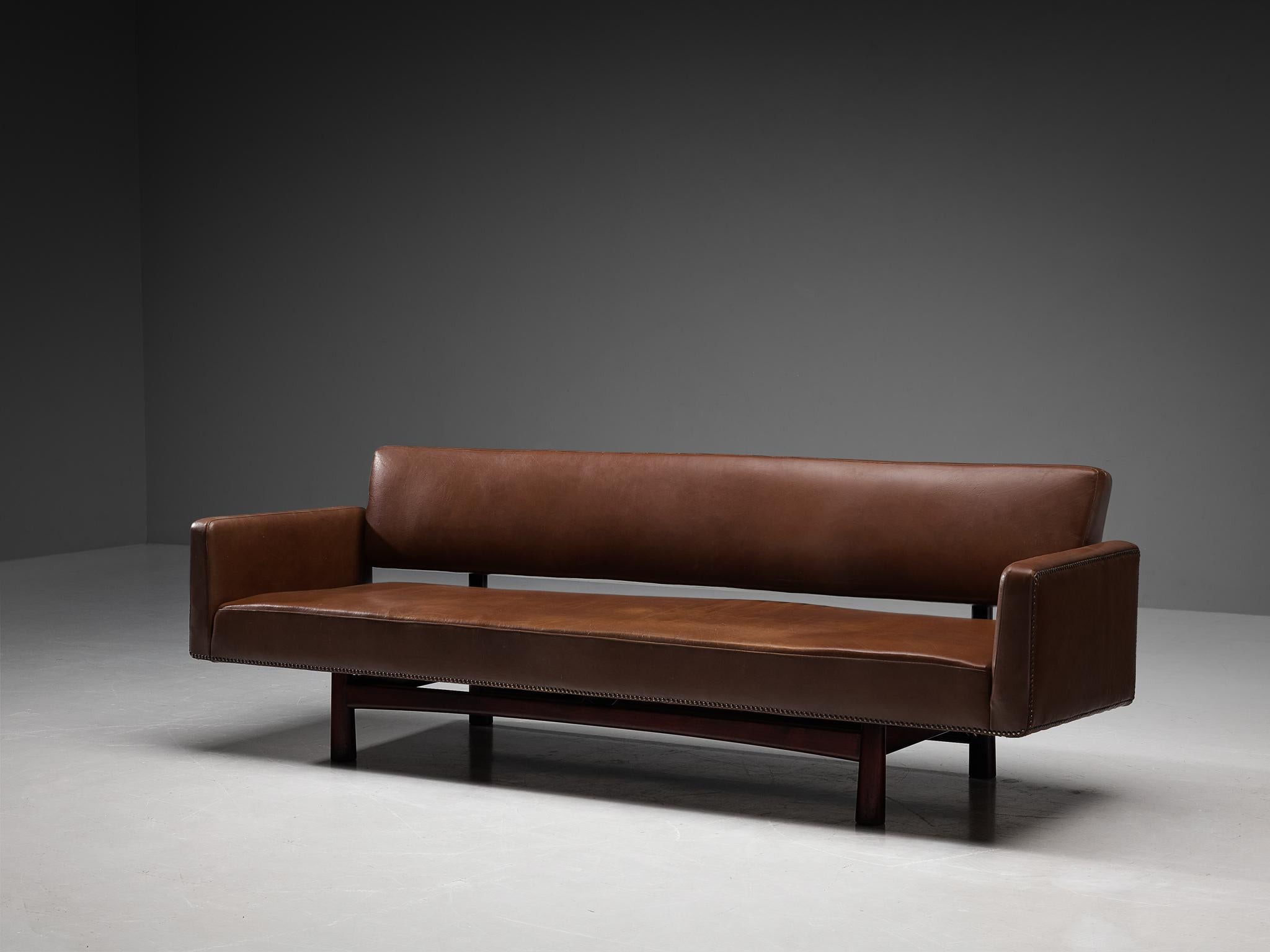 Edward Wormley for Dunbar Furniture / DUX of Sweden, sofa model 5316, faux leather, metal, wood, United States, design 1952

This three-seat sofa was designed by Edward Wormley for Dunbar in 1952. The eye-catching leatherette with metal studs that