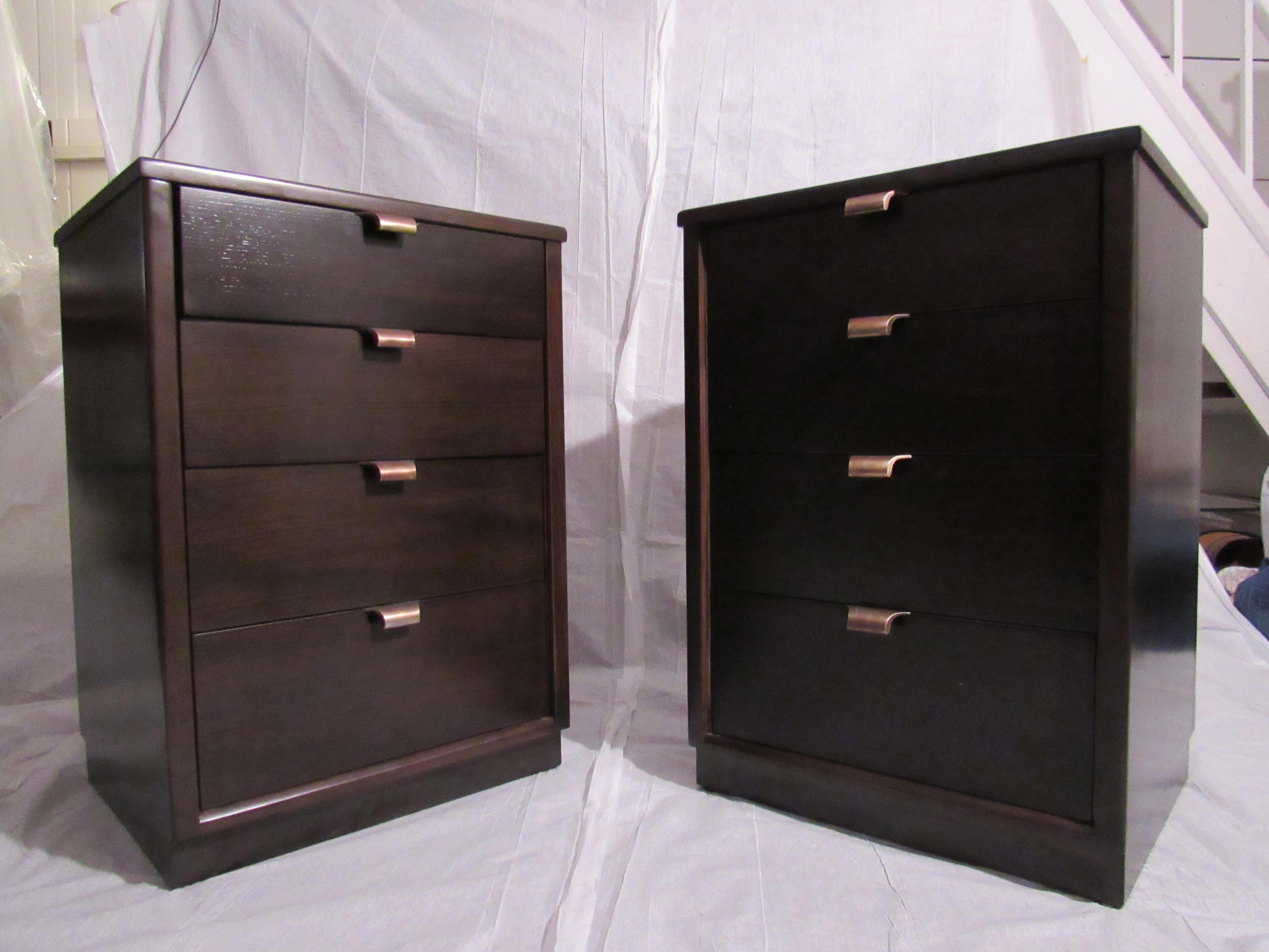 Edward Wormley pair of nightstands for the Precedent collection by Drexel, circa 1947
The pair of silver elm nightstands have been refinished in a black brown espresso finish with polished brass hardware. 
The nightstands are in very good