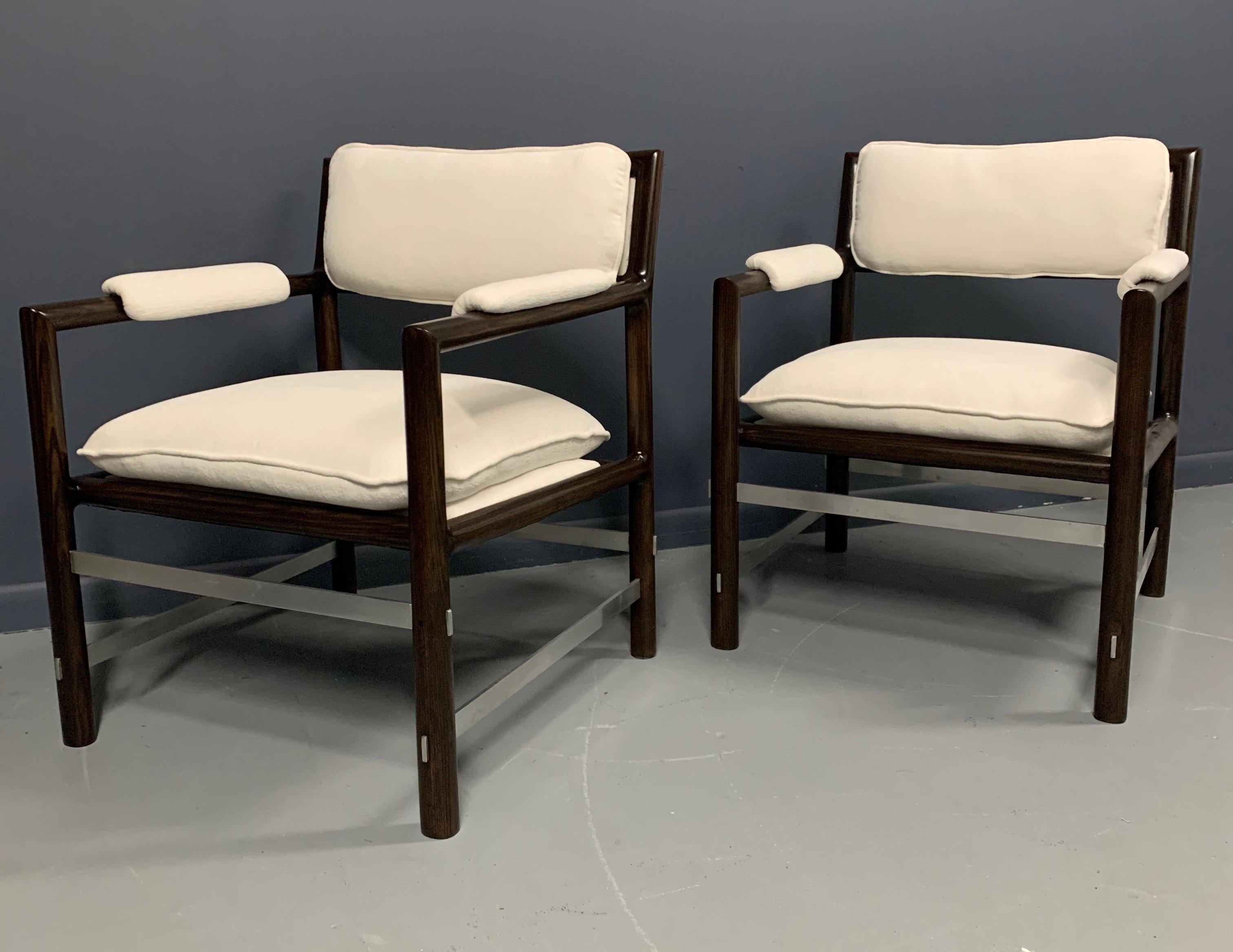 Stunning pair of Edward Wormley for Dunbar armchairs. Dark African mahogany frames with intersecting brushed steel cross stretchers. Newly upholstered in a white textured velvet.