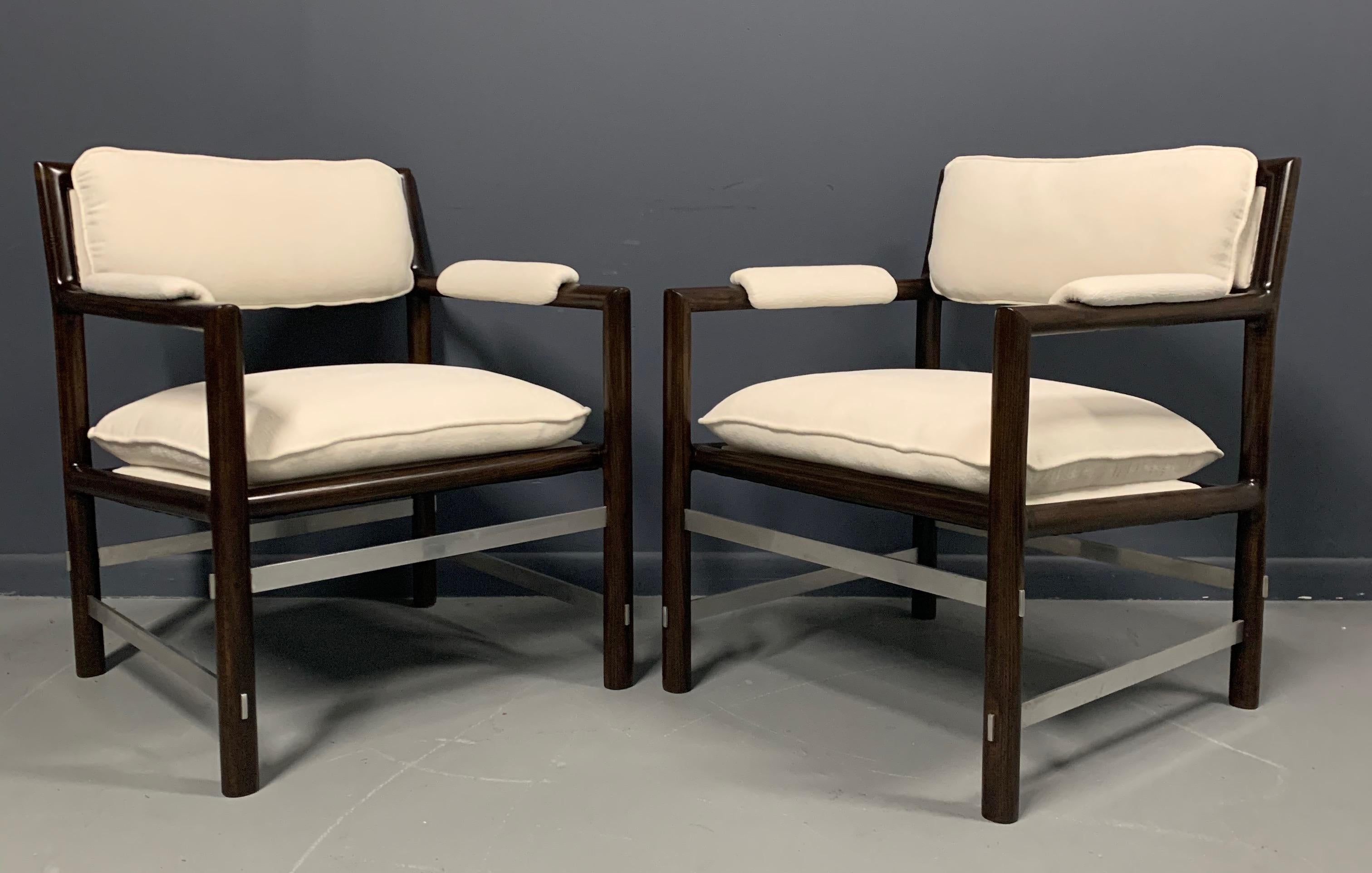 Stunning pair of Edward Wormley for Dunbar armchairs. Dark African mahogany frames with intersecting brushed steel cross stretchers. Newly upholstered in a white textured velvet.