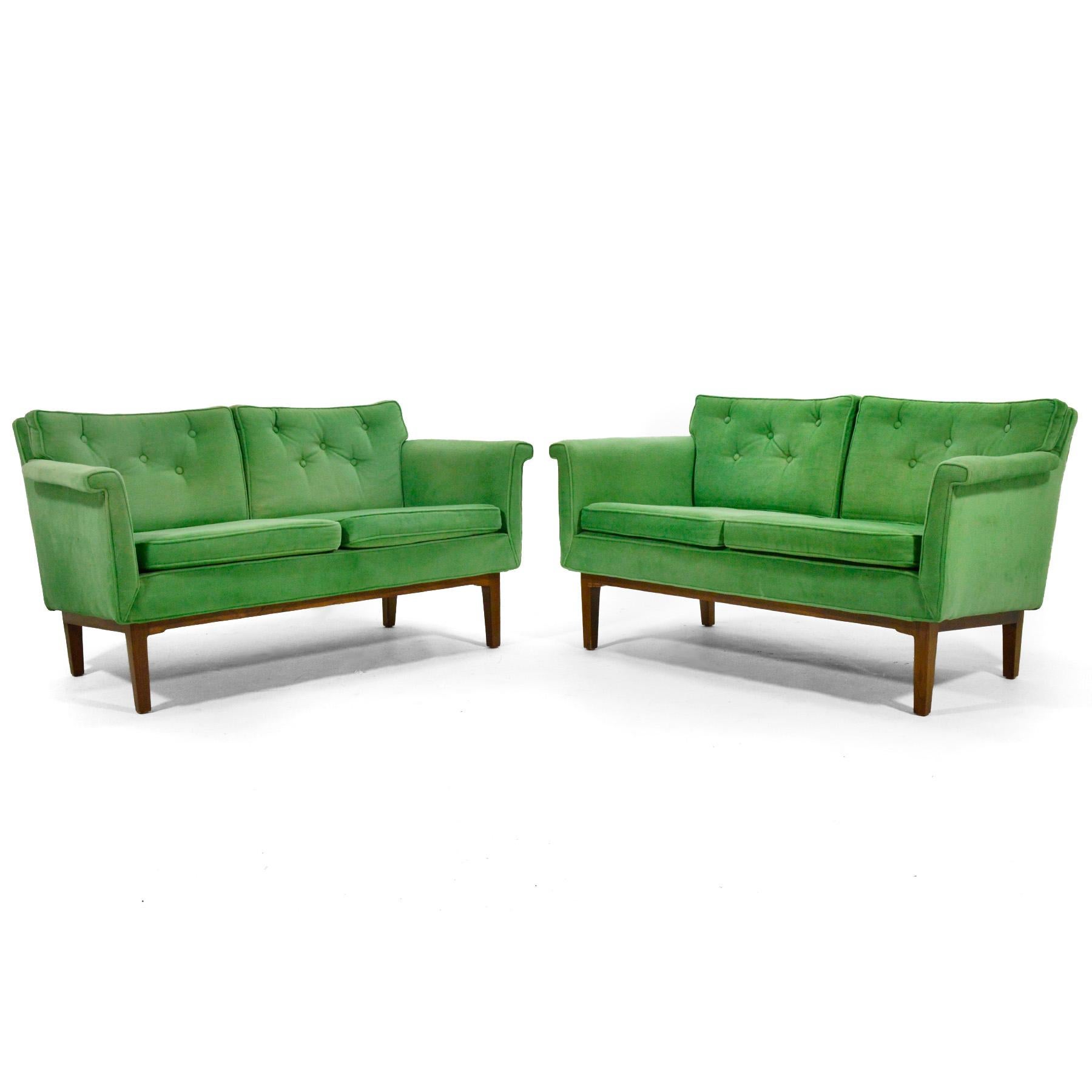 These lovely, lightly scaled sofas or loveseats designed by Edward Wormley for Dunbar, are not only an uncommon form, having a matched pair available is also very rare. They are structurally sound, but the upholstery shows its age and will need to