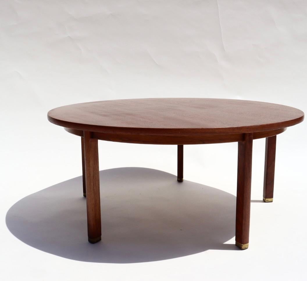 This is a rare Edward Wormley round coffee table for Dunbar in walnut and brass. This is a beautiful Mid-century modern table made with high-quality walnut. This table is an excellent example of Wormley's work, which exhibits his traditional