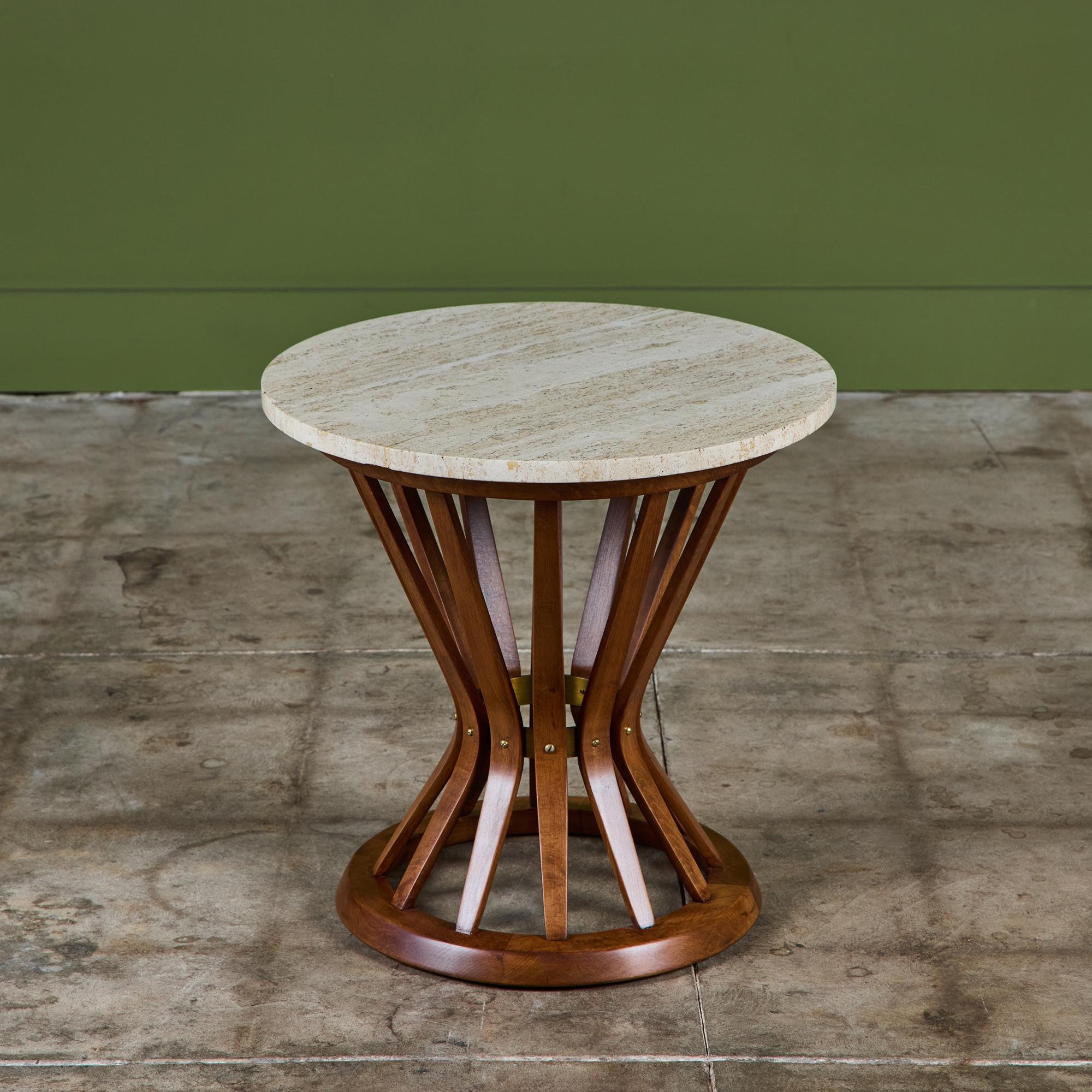 Round side table by Edward Wormley for Dunbar, c.1950s, USA. This table features a round travertine slab top, which rests atop dark contrasting mahogany sheaf of wheat base. Retains original Dunbar metal label on the underside.

Dimensions
20