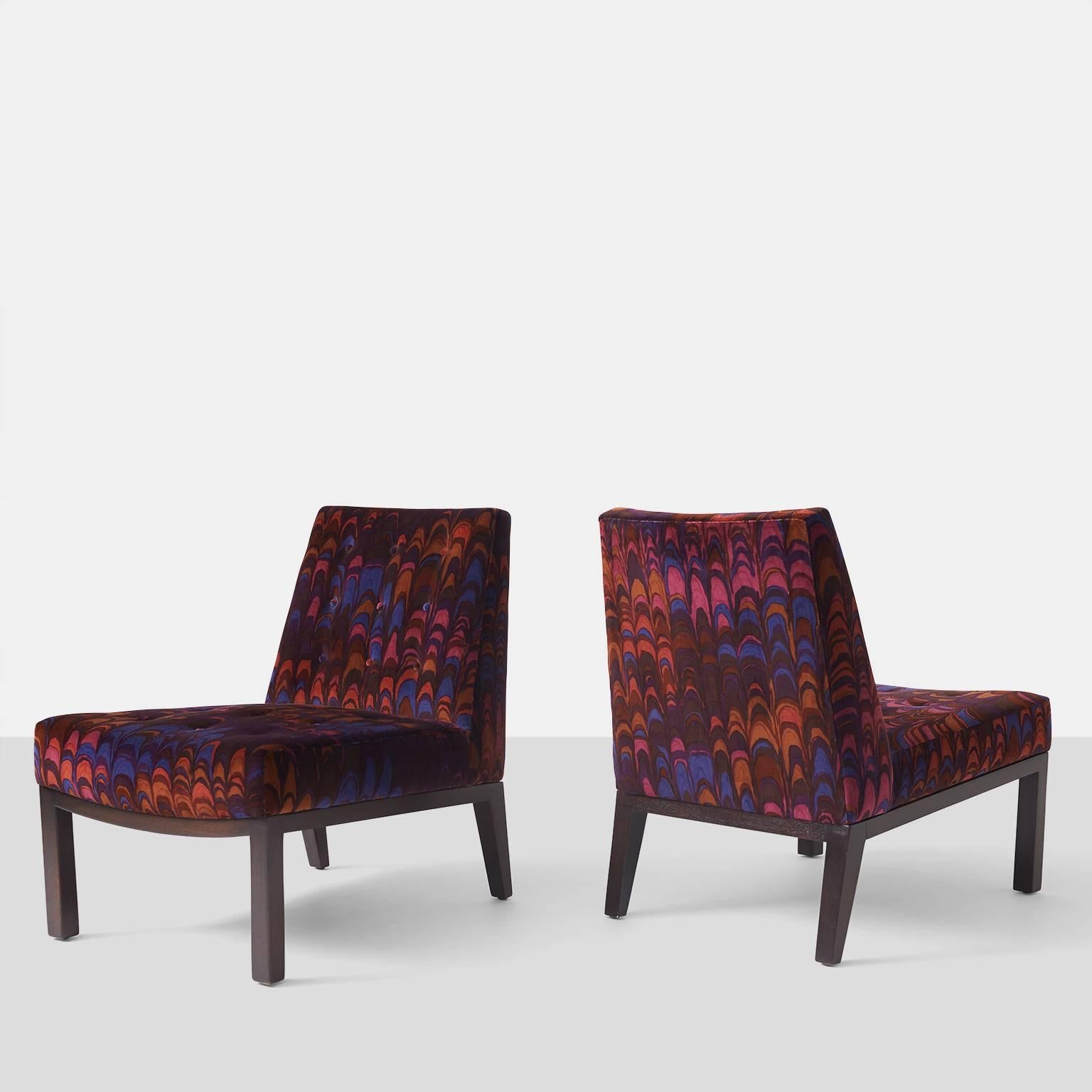 A pair of slipper chairs with tufted seat and back by Edward Wormley for Dunbar. Chairs have been upholstered in a Jack Lenor Larsen velvet and frames are mahogany.