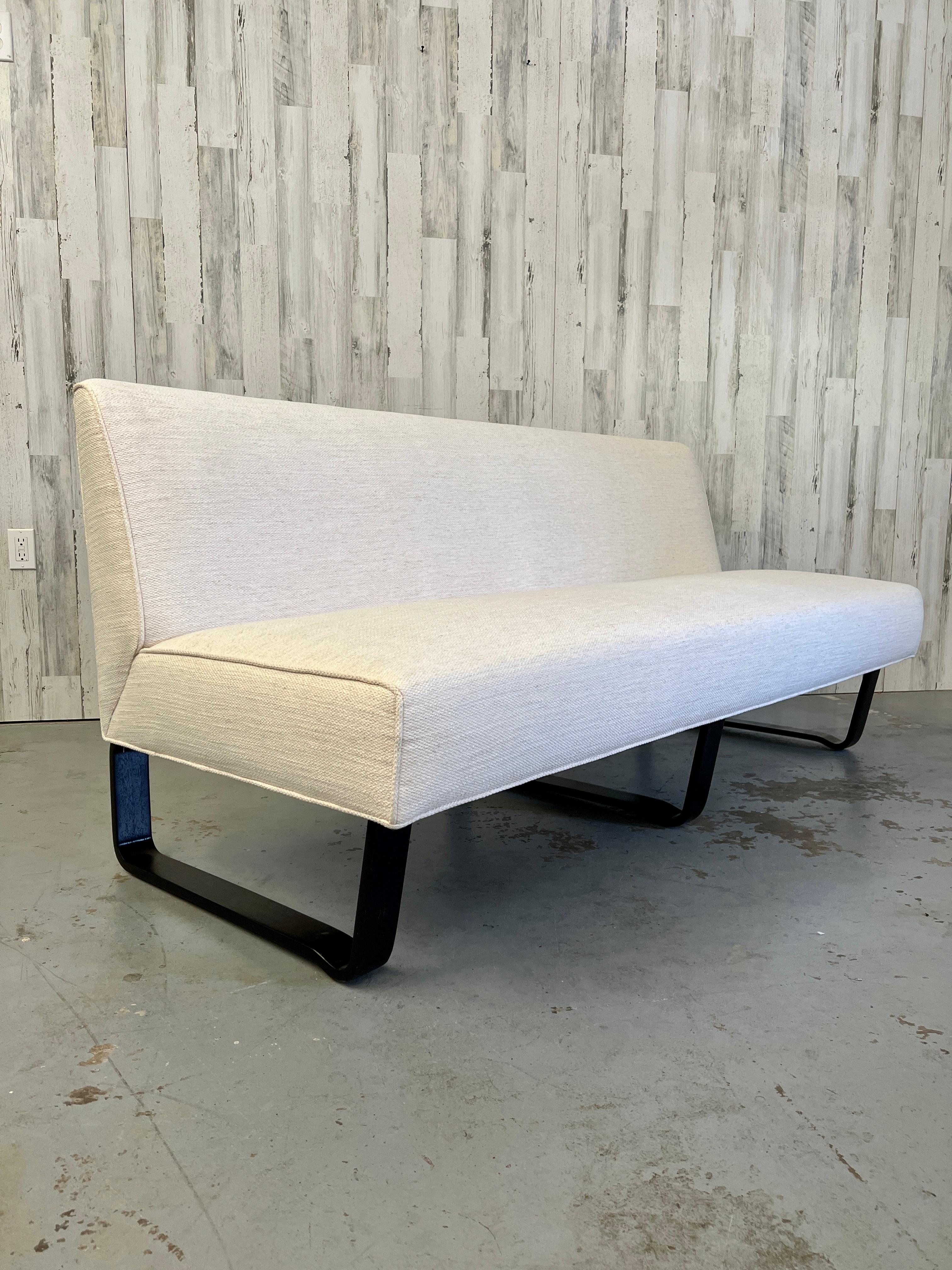 Edward Wormley slipper sofa for Dunbar with off white upholstery and ebonized bentwood legs.
Older restoration.