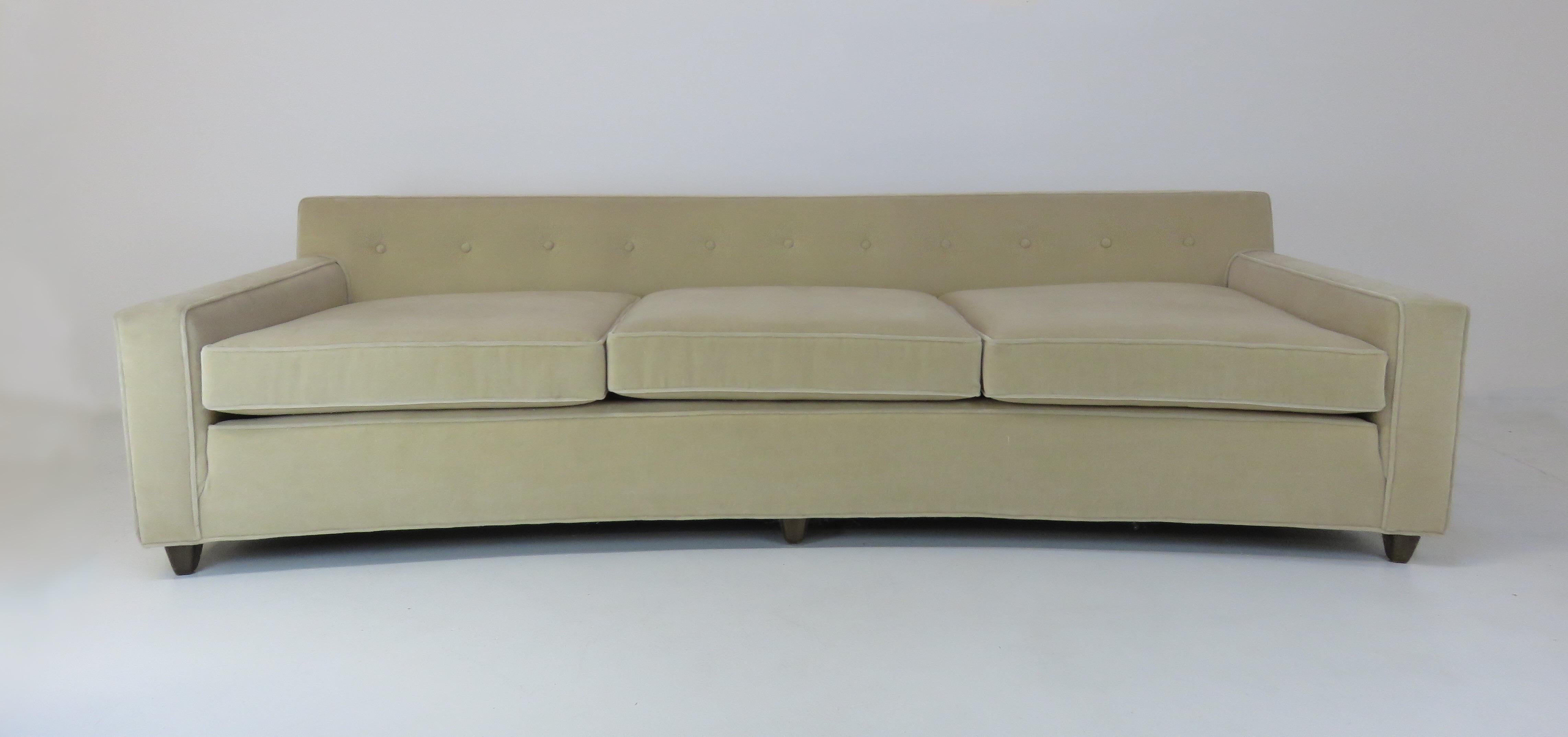 A wide, curved sofa by Edward Wormley sofa for Dunbar. Upholstered in a beige mohair.