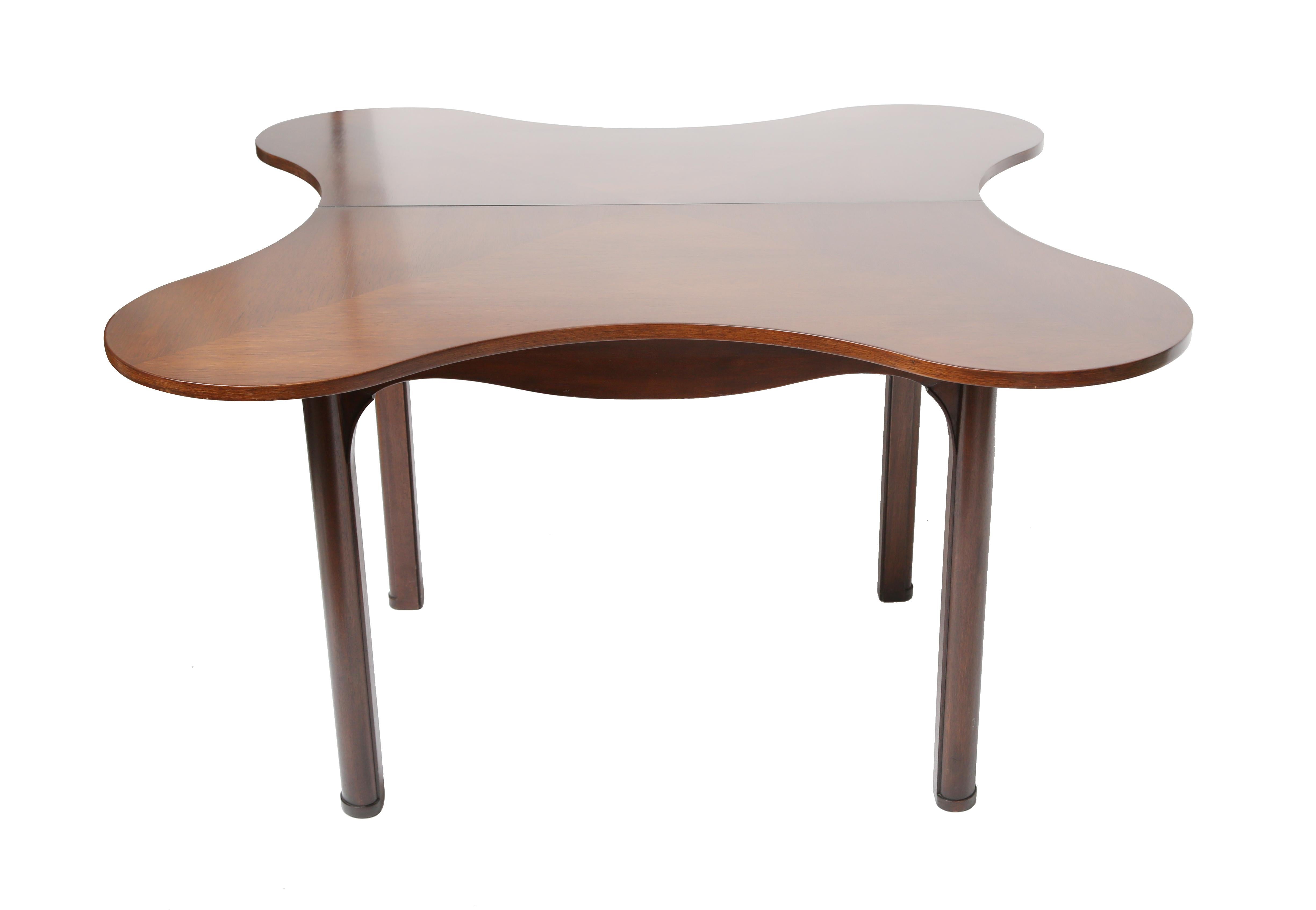 A beautiful and practical design.
The table utilizes bookmatched veneer to create an optic pattern.
Hidden compartment for silverware.
Probably a custom design.