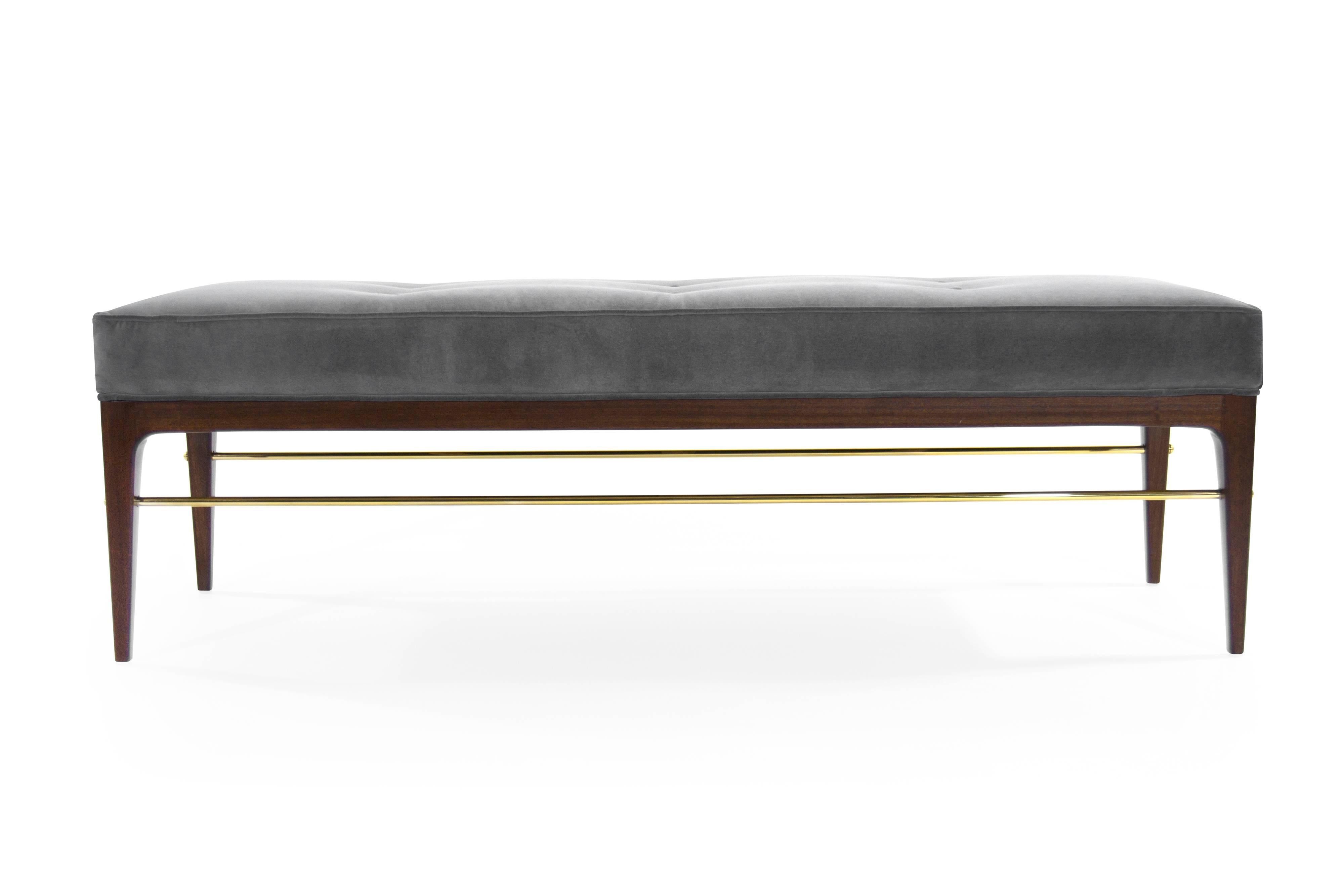 Midcentury inspired mahogany bench in the style of Edward Wormley and Paul McCobb.
Shown in solid mahogany, fitted with a brass stretcher, fastened in place by brass caps. Upholstered in granite velvet. Available immediately.
 