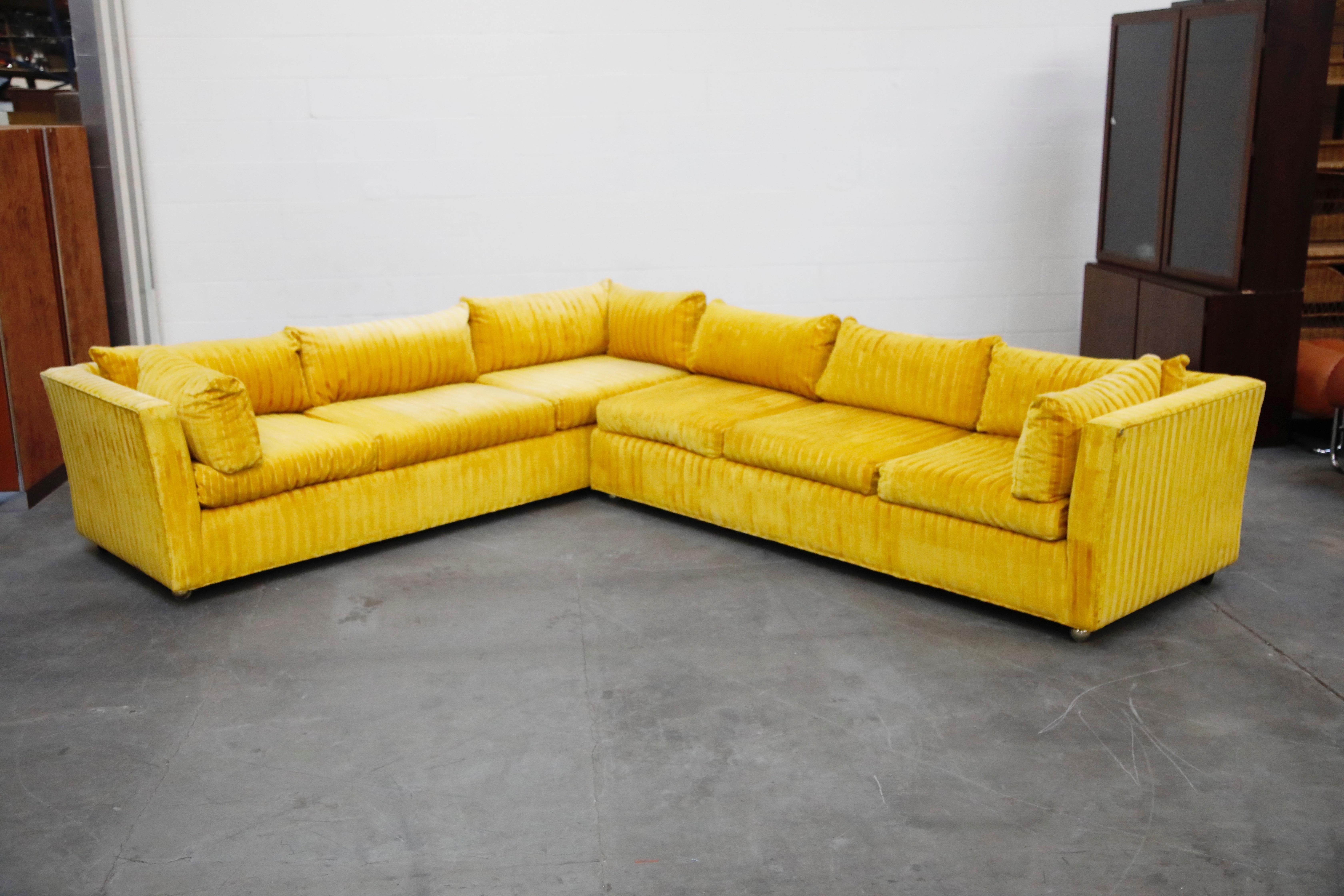 This large and incredible Edward Wormley styled two-piece sectional sofa would make an impact to any space. Upholstered in a quality Jack Lenor Larsen styled yellow and orange striped velvet fabric which is in excellent condition with no major