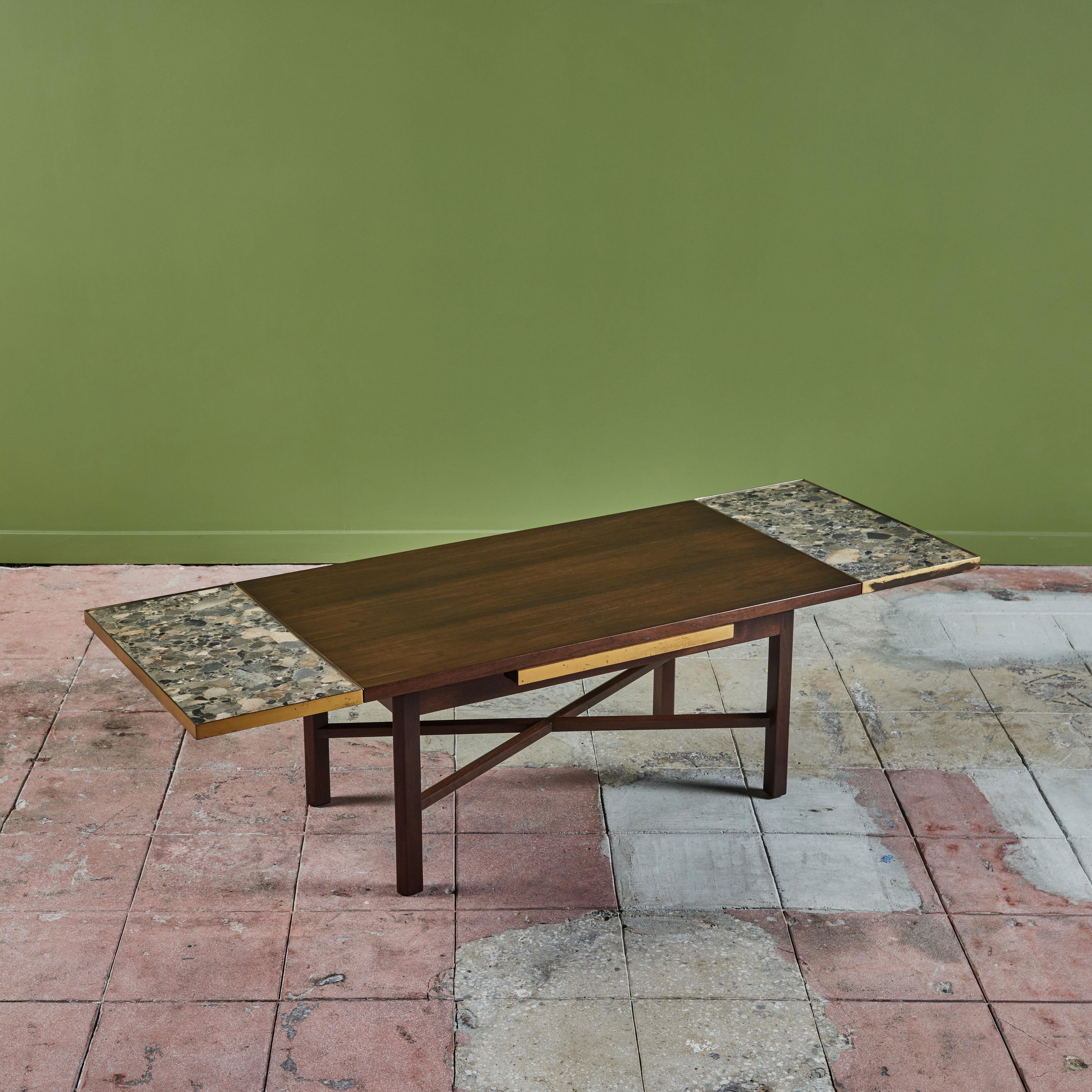 Edward Wormley extending coffee table for Dunbar, c.1960s, USA. The walnut table features a brass edge detailing around all sides of table. Once extended the table reveals two stone inlayed extensions from beneath the tables surface that 