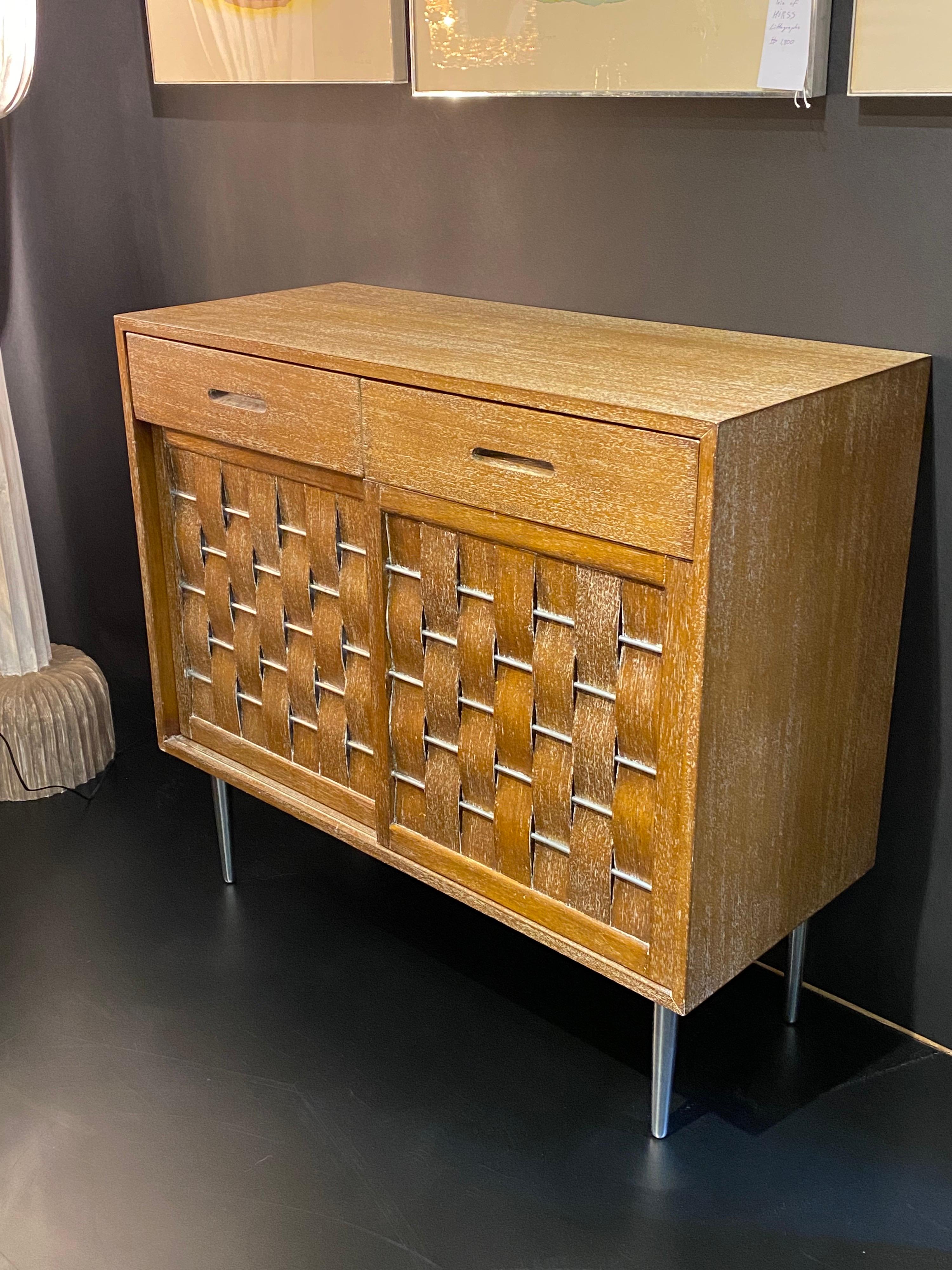 Edward Wormley woven front bleached and cerused mahogany cabinet / commode with aluminum legs. Two available, priced individually.