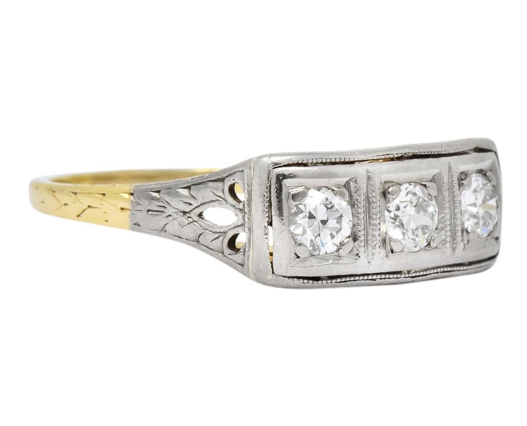 Centering three old European cut diamonds, weighing approximately 0.30 carat total, H/I color and VS clarity

In platinum square form settings atop a detailed pierced gold gallery

Stamped 14K and PLAT with maker’s mark (all worn)

CTW: 0.30

Ring