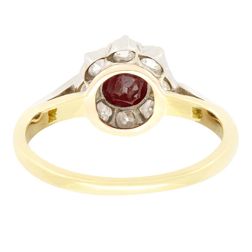 This delightful Edwardian cluster ring features a vibrant 0.40 carat old cut ruby, at it’s centre. Surrounding the ruby, a sparkling halo of old cut diamonds totals 0.40 carats, with an additional 0.06 carats of diamonds delicately set down each