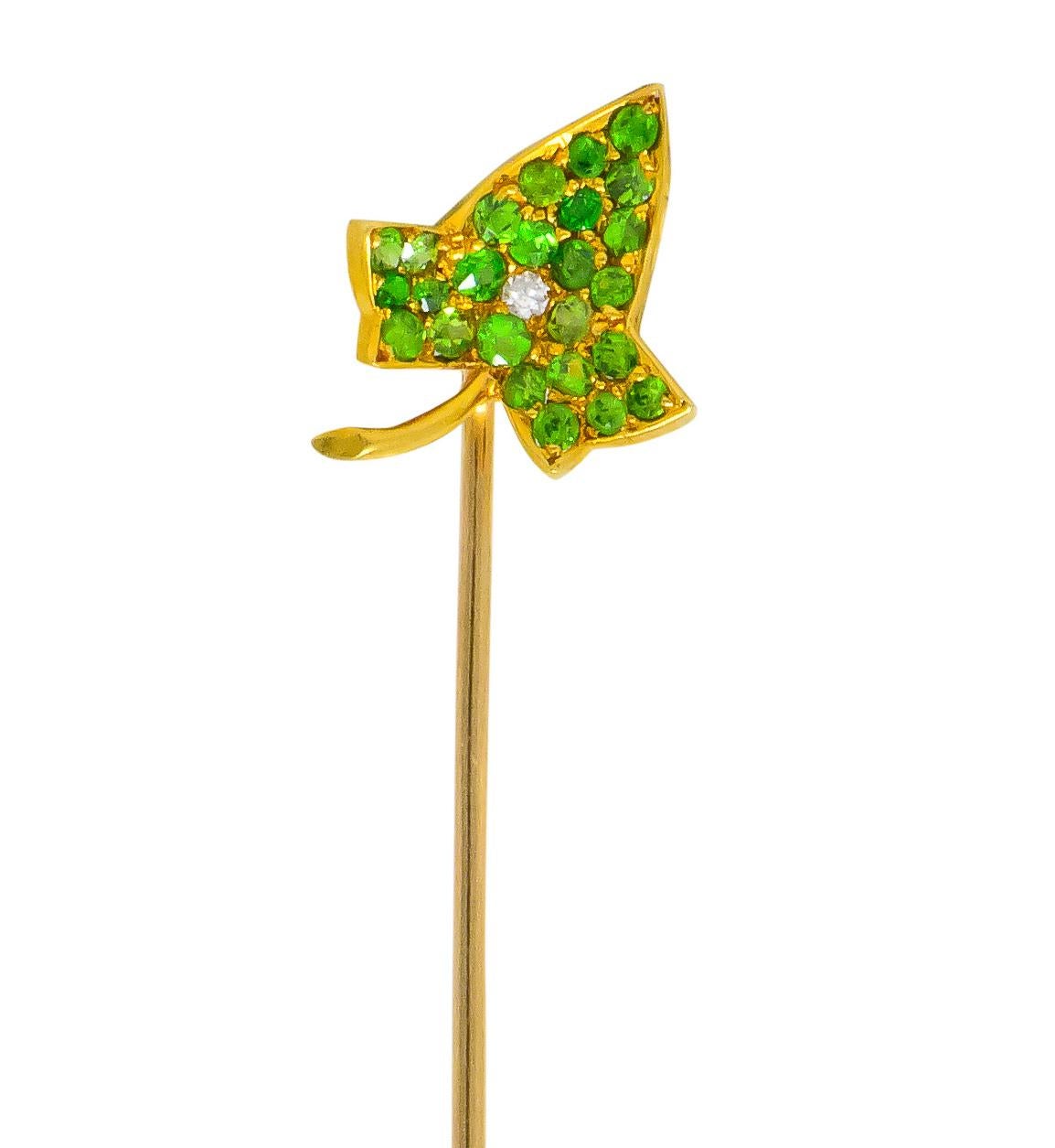 Featuring an ivy leaf pavé set throughout with rose cut demantoid garnets weighing approximately 0.50 carat total, transparent and bright yellowish-green in color

Centering a single cut diamond weighing approximately 0.01, eye-clean and white

With