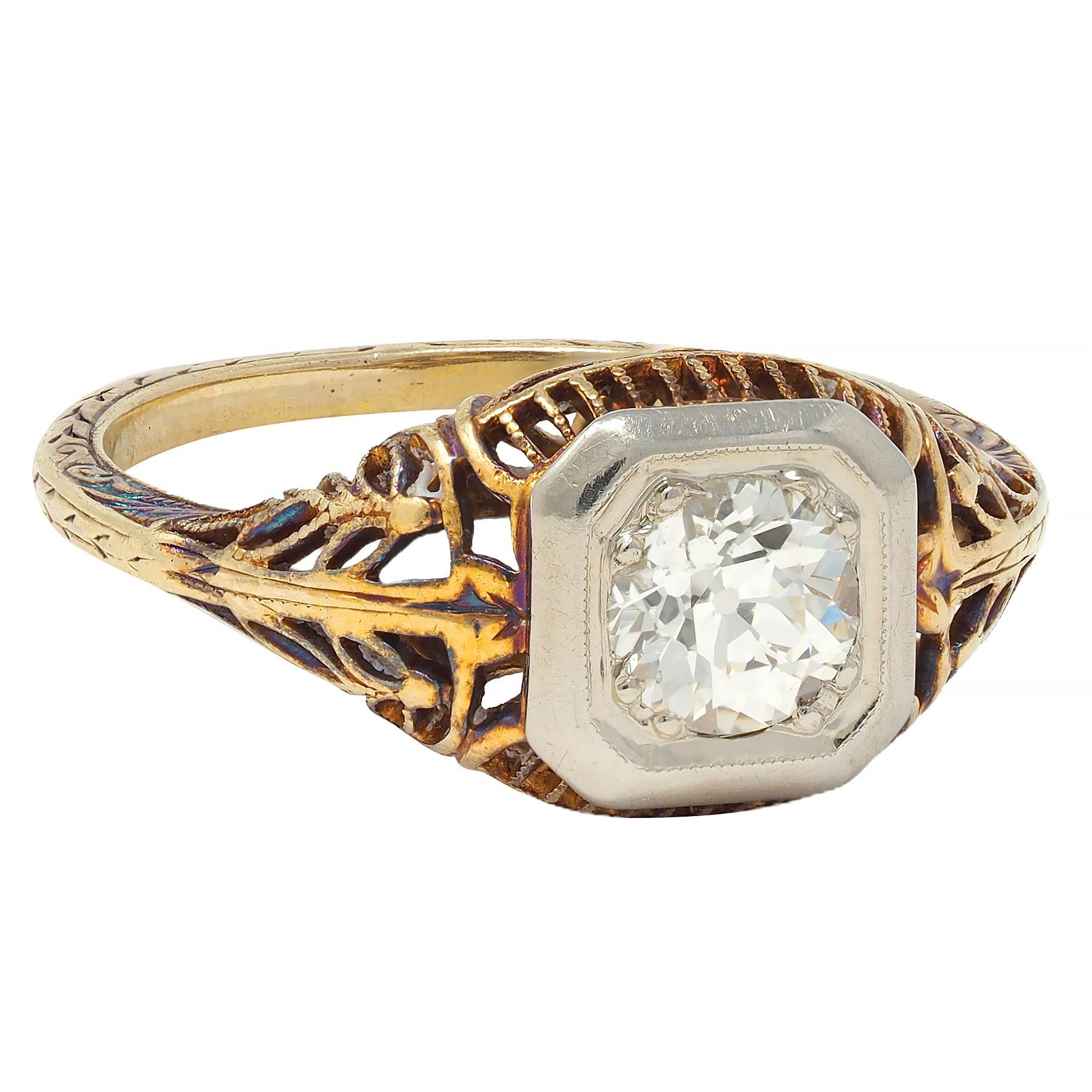 Centering an old European cut diamond weighing approximately 0.55 carat - L color with VS2 clarity
Bead set in a white gold octagonal form head with a pierced yellow gold gallery
Bombé shaped and displaying foliate garland motif openwork
Completed