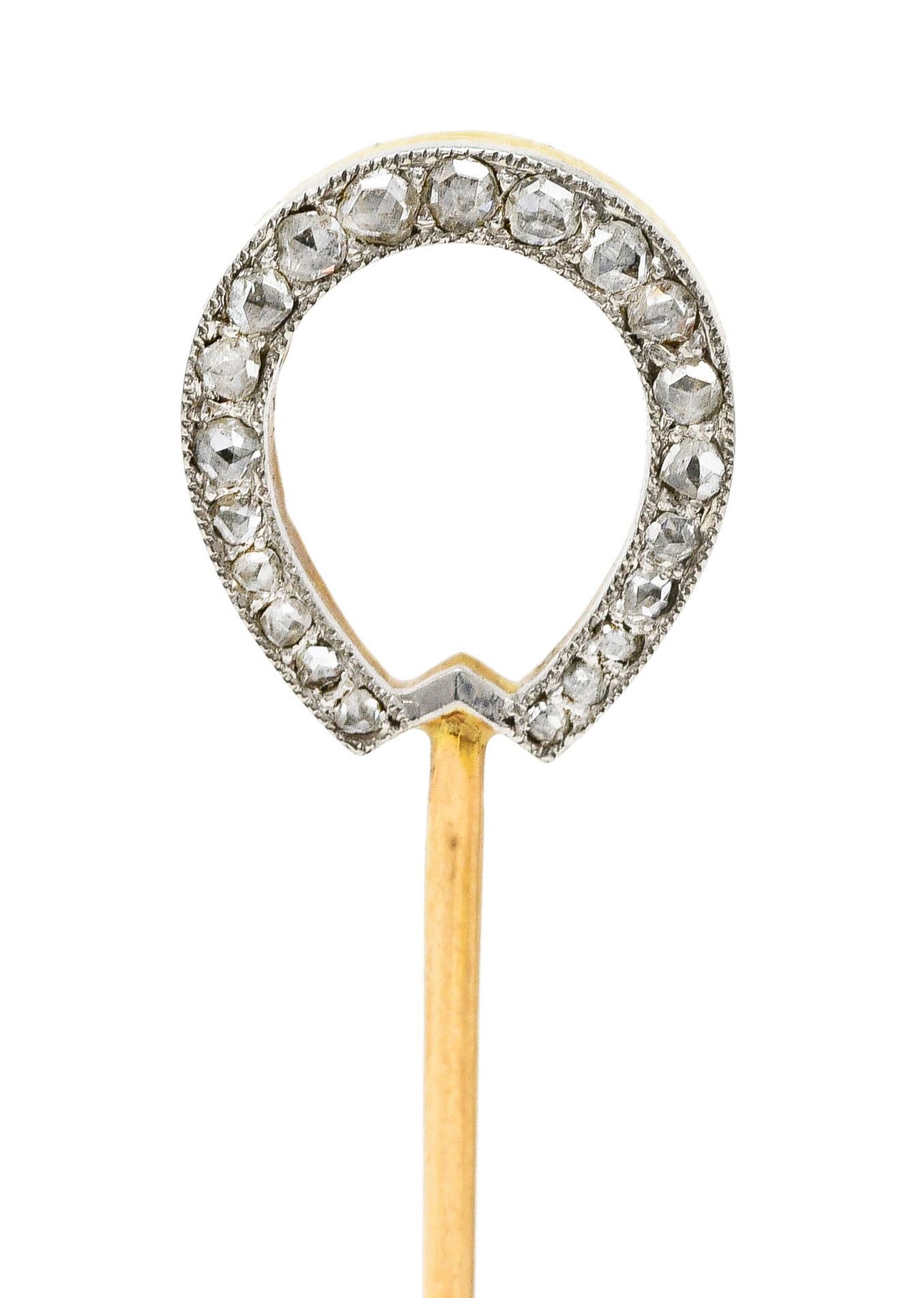 Stickpin depicts an arched horseshoe motif

One side is yellow gold with calibrè cut emeralds

While opposite side is platinum with milgrain and rose cut diamonds

Emeralds are well matched and vividly green while weighing approximately 0.40 carat