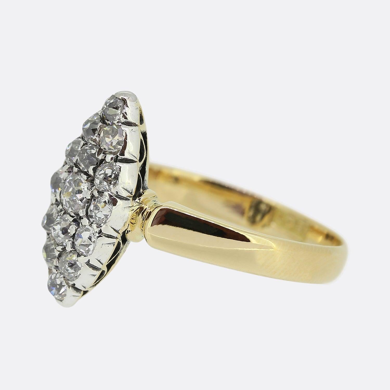 Here we have an antique diamond navette ring from the Edwardian era. The piece showcases a boat-like shaped face which has been filled with a vast array of closely claw set old cut diamonds in platinum atop a plain polished 18ct yellow gold band.