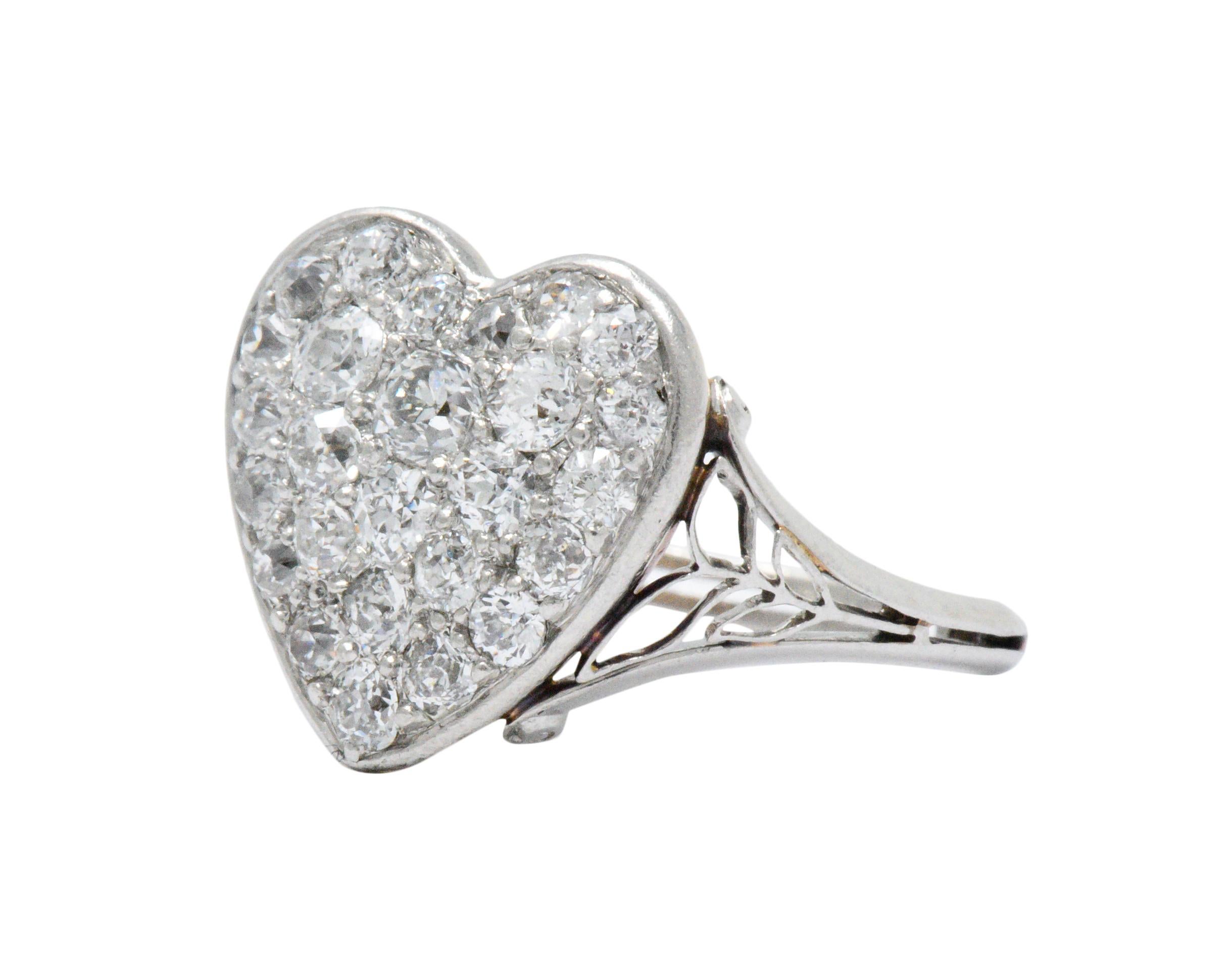 Featuring a heart shaped mount containing pavé set old European and old mine cut diamonds, weighing approximately 0.70 carats total, GHI color, VS to I clarity

Scrolled gold work with foliate motif and pieced shank

Tested as 18k gold and