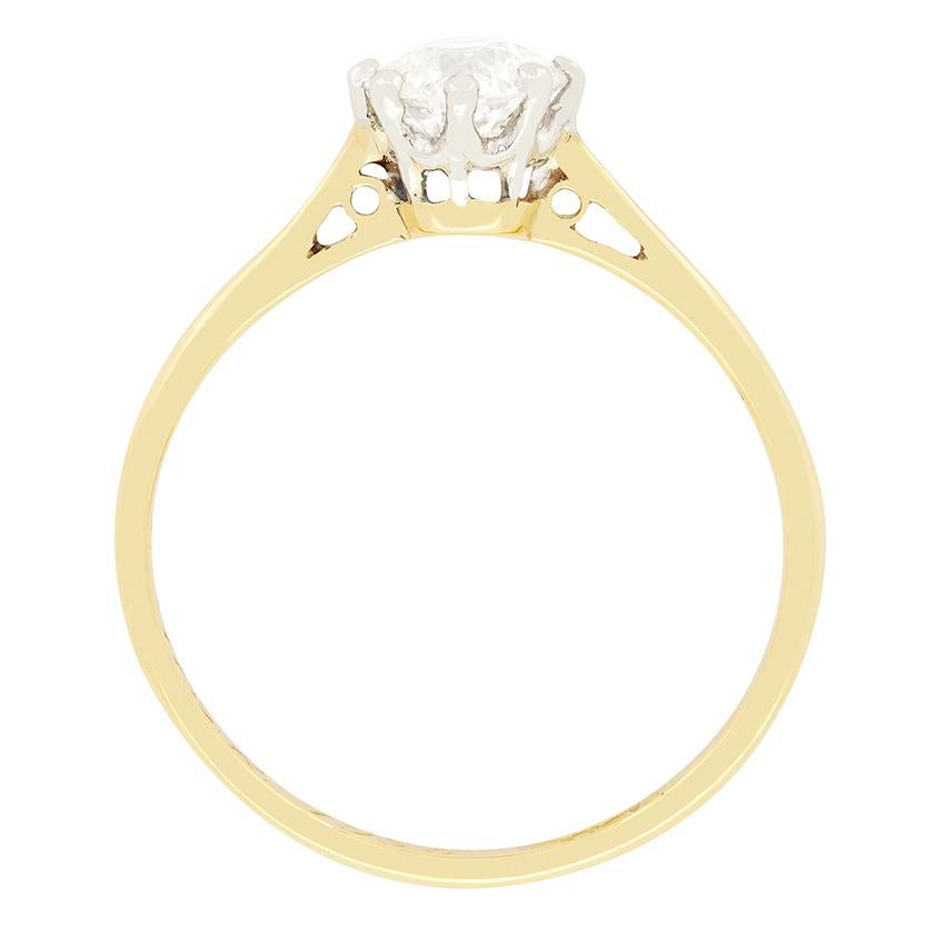 A 0.75 carat old cut diamond sits proudly in this classic Edwardian solitaire ring. The sparkling diamond has a colour of H and clarity of SI1. The stone is claw set into a collet of platinum, whilst a tapering band of 18 carat yellow gold completes