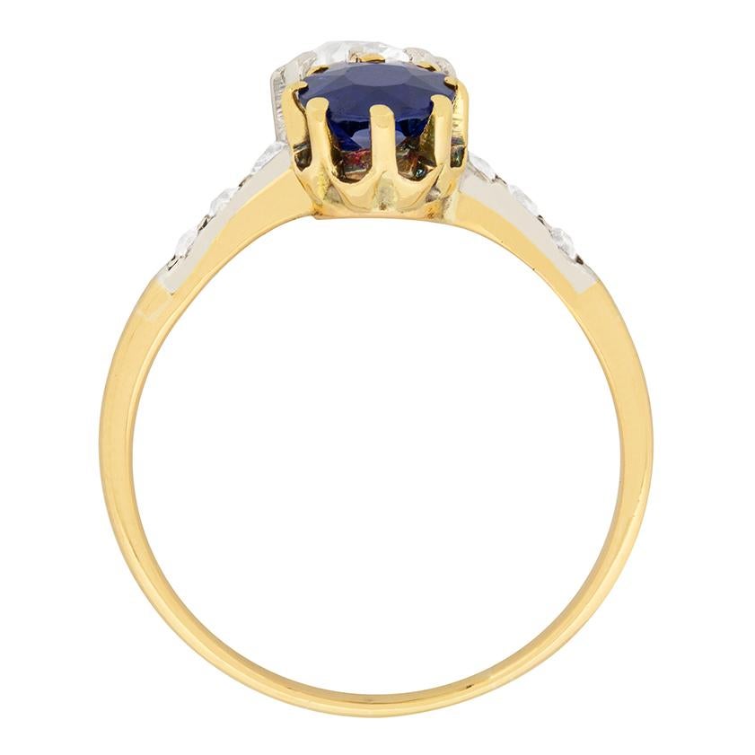 This gorgeous Edwardian ring features a diamond and a blue sapphire set in a lovely twist. The 0.80 carat blue sapphire is an excellent deep blue colour and is certified as natural, with no signs of heat treatment. The old cut diamond is 0.87 carat