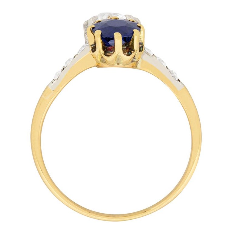 This gorgeous Edwardian ring features a diamond and a blue sapphire set in a lovely twist. The 0.80 carat blue sapphire is an excellent deep blue colour and is certified as natural, with no signs of heat treatment. The old cut diamond is 0.87 carat