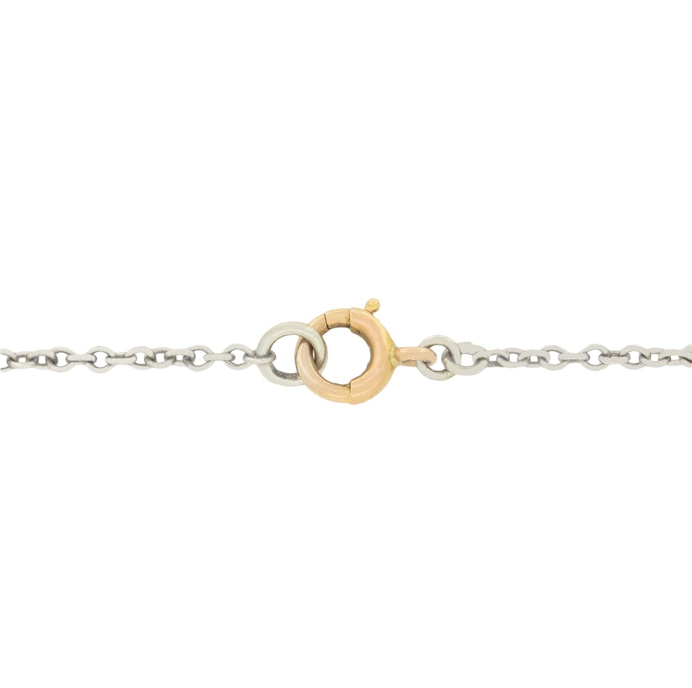 This charming Edwardian necklace features a diamond set bow design, crafted in platinum. Suspended below are two finely detailed 15 carat yellow gold acorn drops, adorned with vibrant blue enamel, golden leaves, and rose cut diamond. The diamonds