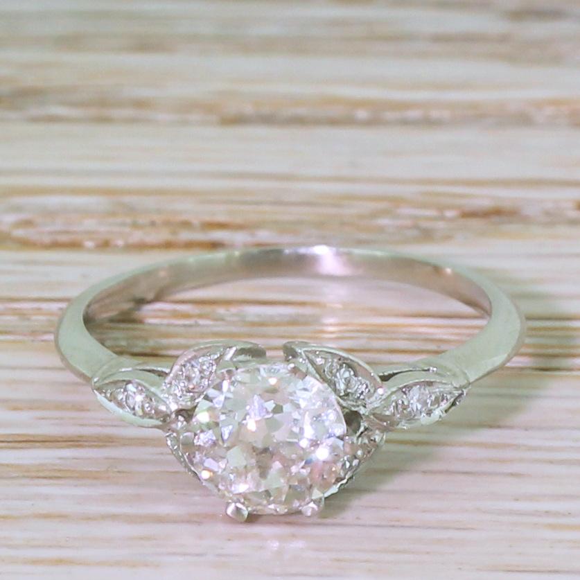 A perfectly balanced Edwardian engagement ring. The central old cut diamond – graded by HRD as H colour, VS1 clarity – is high white, internally clean, and set in a six claw collet leading to a gorgeous trefoil design set with six (three either