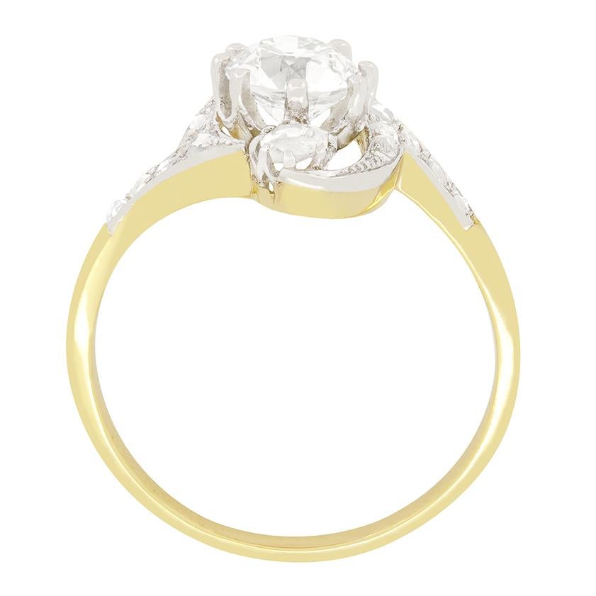 This ring from the Edwardian period features a truly unique design. The vertical three diamonds are enveloped in a twisting band to create an eye catching piece. Taking centre stage is a 1.01 carat old cut diamond. The beautiful stone has been