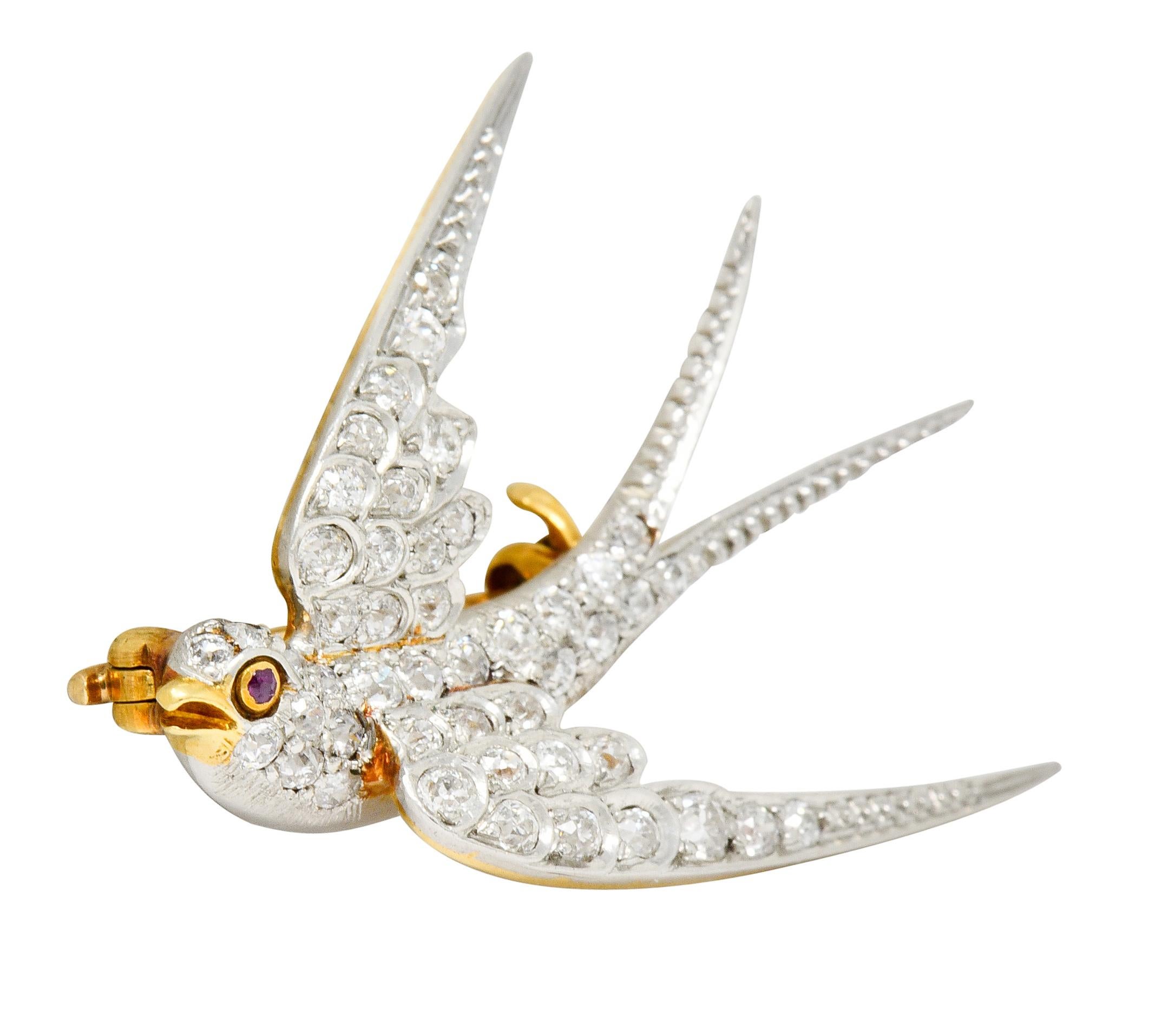 Depicting a stylized swallow in flight with delicately engraved tail and stylized scallop motif feathers

Set throughout by old European cut diamonds weighing in total approximately 1.06 carats, G to I color with SI clarity

Accented by a polished