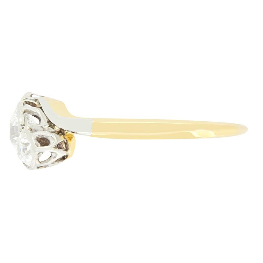 A beautiful spin on the classic trilogy design, this Edwardian ring features three glittering old cut diamonds set diagonally at its centre. The main diamond is 0.60 carat, with the diamonds to either side weighing 0.25 carat a piece. The stones