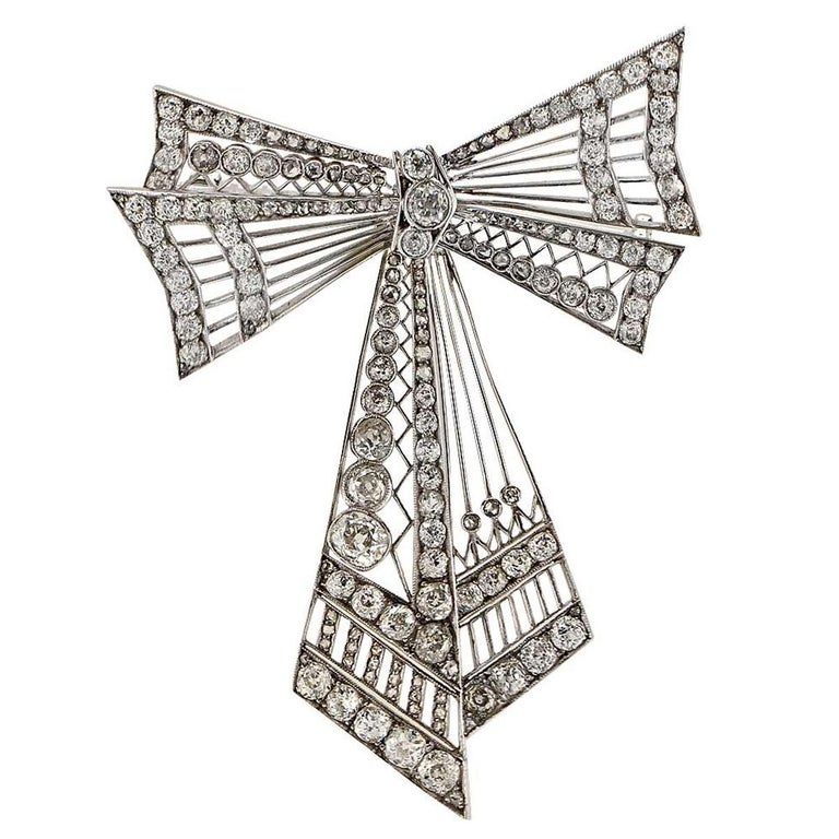 This spectacular platinum Edwardian bow pin is set with approximately 11.25cts of European and old mine cut diamonds F-H color and VS clarity.

The brooch measures 3 inches in height by 2.25 inches in width by .50 inch in depth.
It is stamped and/or