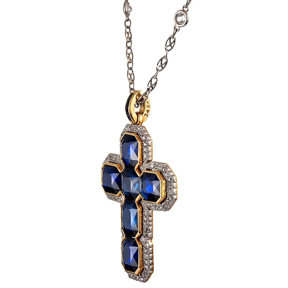 A stunning display of cushion sapphires, assembled into the shape of a cross and bordered in a thin bezel of 18 karat yellow gold. The cross is then further framed in a platinum diamond-set halo with old European cuts. It’s stunning. The sapphires