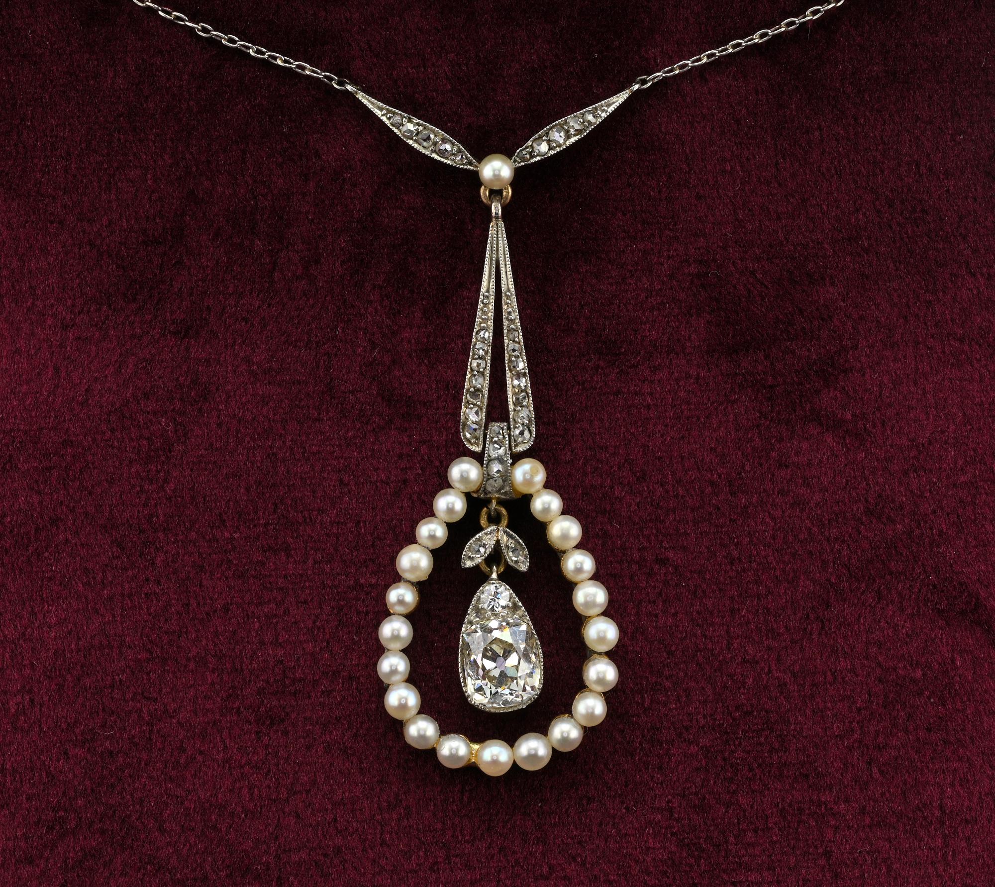 Edwardian period 1900 circa necklace, crafted of Platinum and 18 kt gold
Design is of infinite elegance and grace, hanging from a Platinum chain a pear drop of natural micro pearls, framing a centre Cushion cut Diamond solitaire topped by another