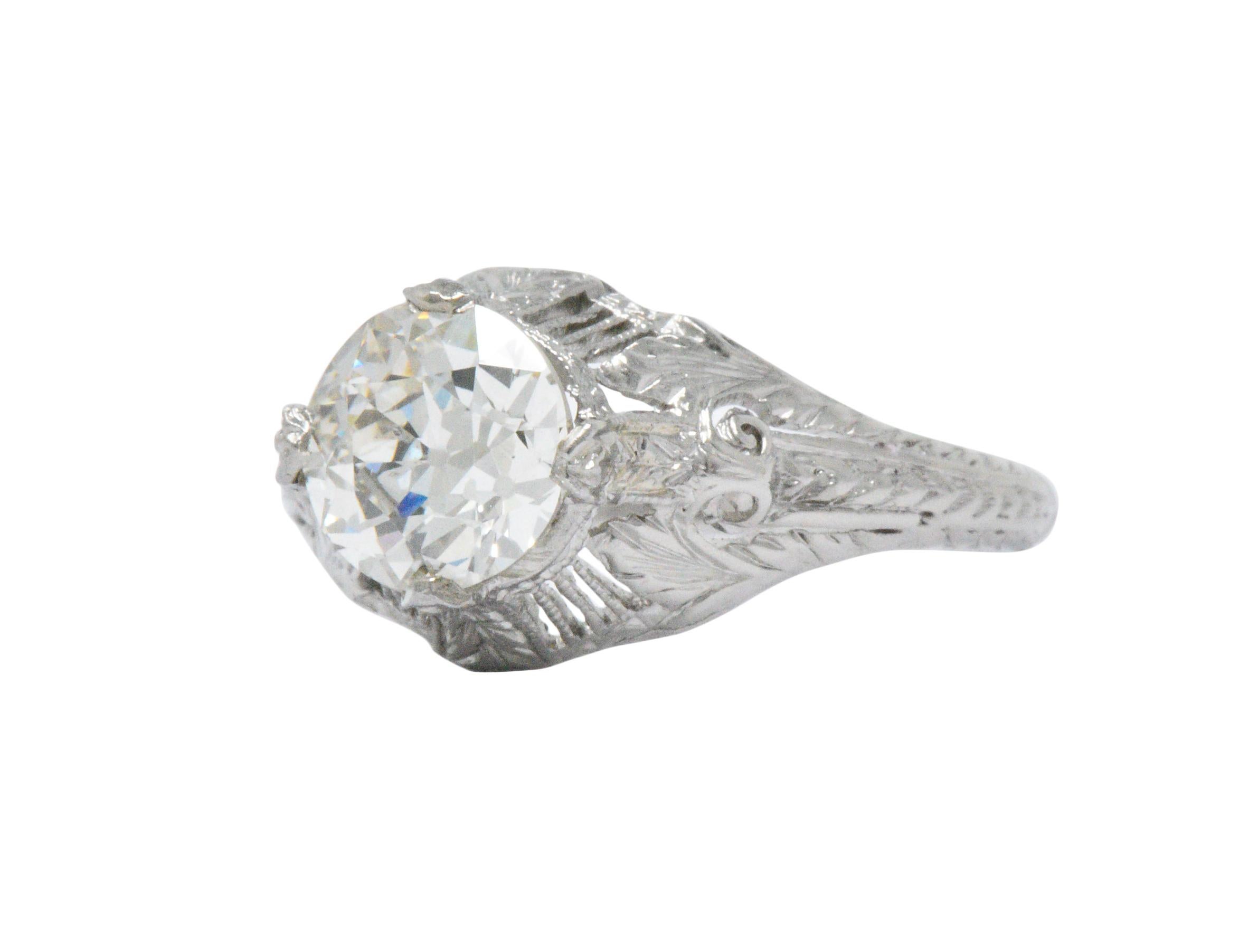Centering an old European cut diamond weighing 1.25 carats, K color and SI1 clarity, accompanied by GIA Diamond Grading Report

Pierced millegrain and hand engraved platinum mount

Appealing North, East, South, West setting

Signed 