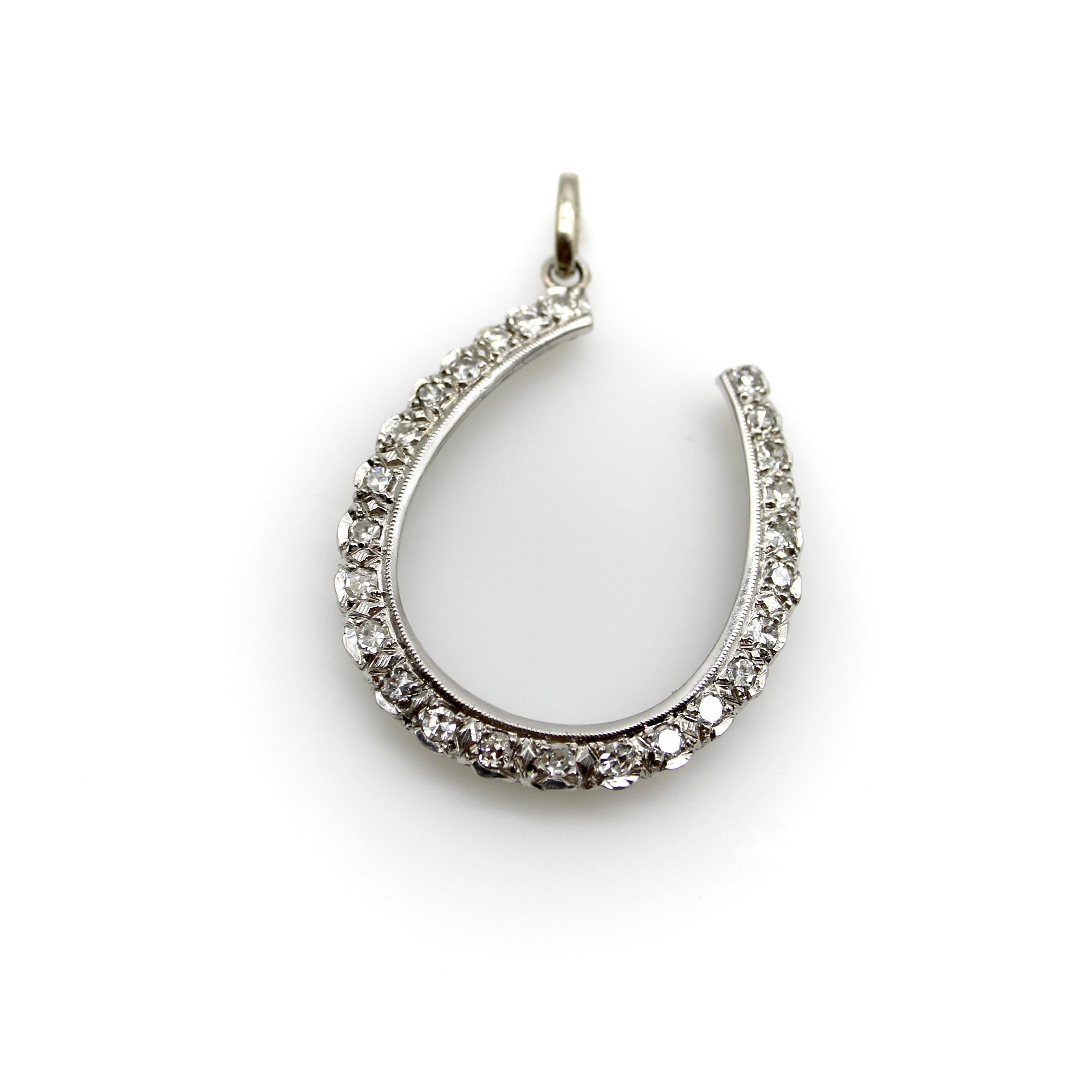 Circa 1900, this 12k gold lucky horseshoe pendant contains 25 sparkling single cut diamonds bead set with bright cut work. The setting has scalloped edges along the bottom outside border; the inside border is a nice clean line that balances the