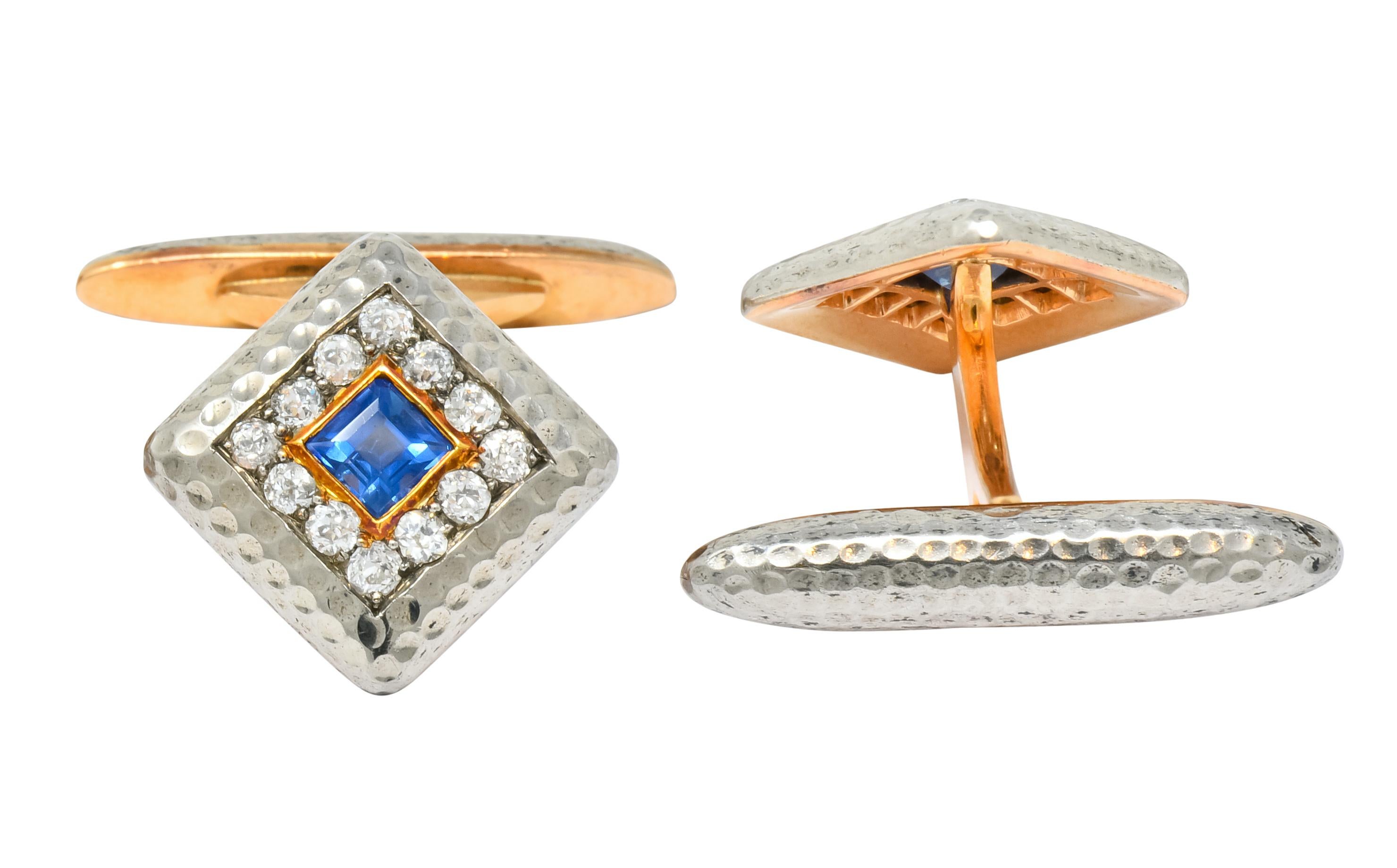 Lever style cufflinks featuring a two-tone navette design with hammered detail

Each centers a square cut sapphire weighing approximately 0.70 carat total, bright cornflower blue in color

Surrounded by bead set old European cut diamonds, weighing