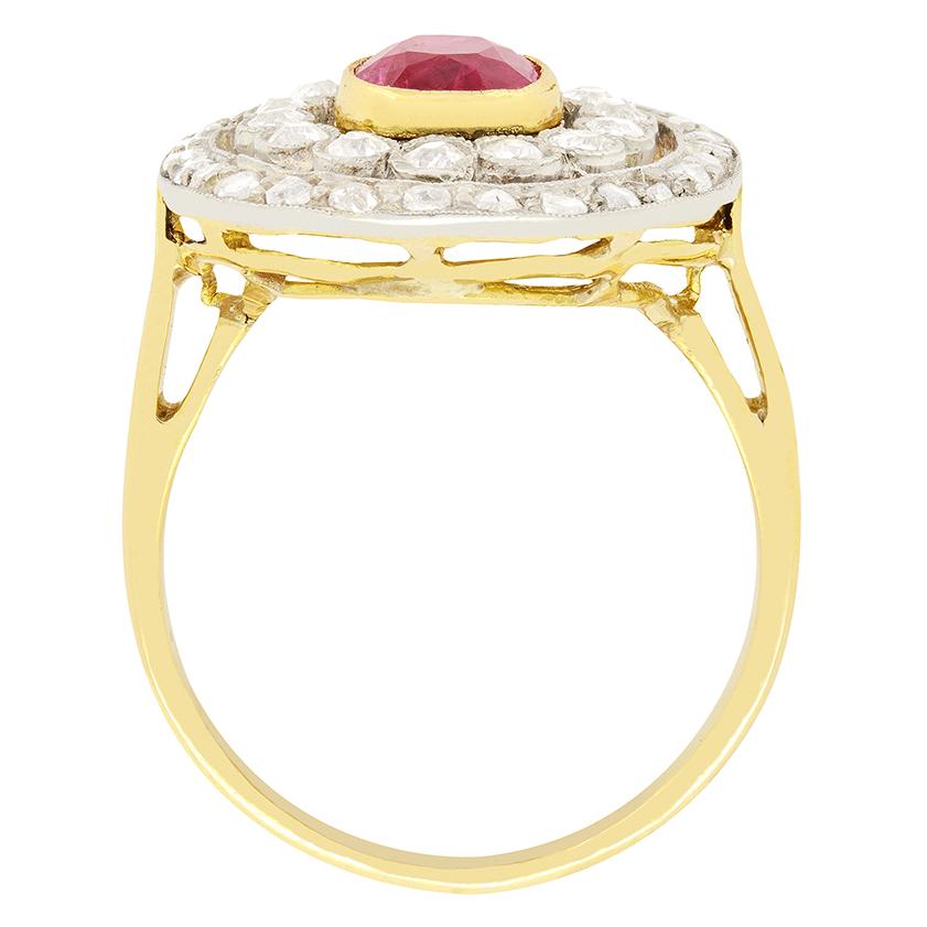 This gorgeous Edwardian ring features a ruby at its centre with two diamond halos surrounding it. The oval cut central ruby is 1.30 carat, natural stone and rub over set into 18 carat. The closest of the two diamond halos features 14 old cut