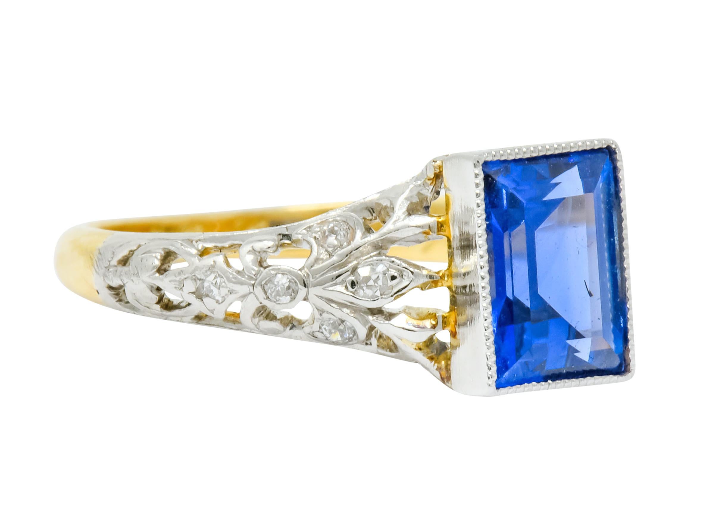 Centering rectangular step cut Ceylon sapphire weighing 1.37 carats; bright blue in color with no indications of heat

Bezel set in milgrain platinum and flanked by ornately pierced foliate shoulder motif 

Accented by single and Swiss cut diamonds