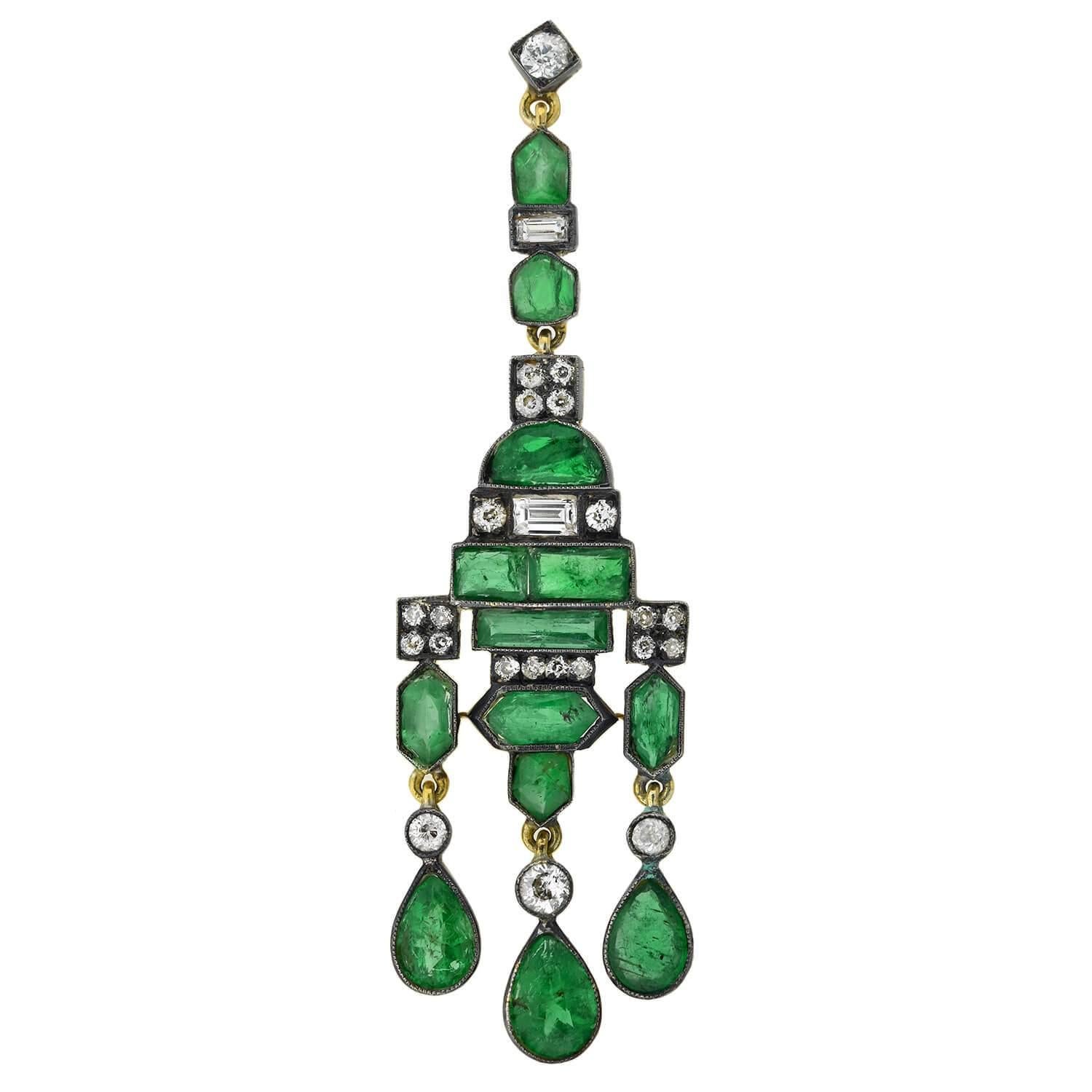 An exquisite pair of gemstone chandelier earrings from the Edwardian (ca1910s) era! Crafted in 14kt yellow gold topped in sterling silver, these incredible earrings are adorned with sparkling diamonds and vibrant emeralds. Each earring displays a
