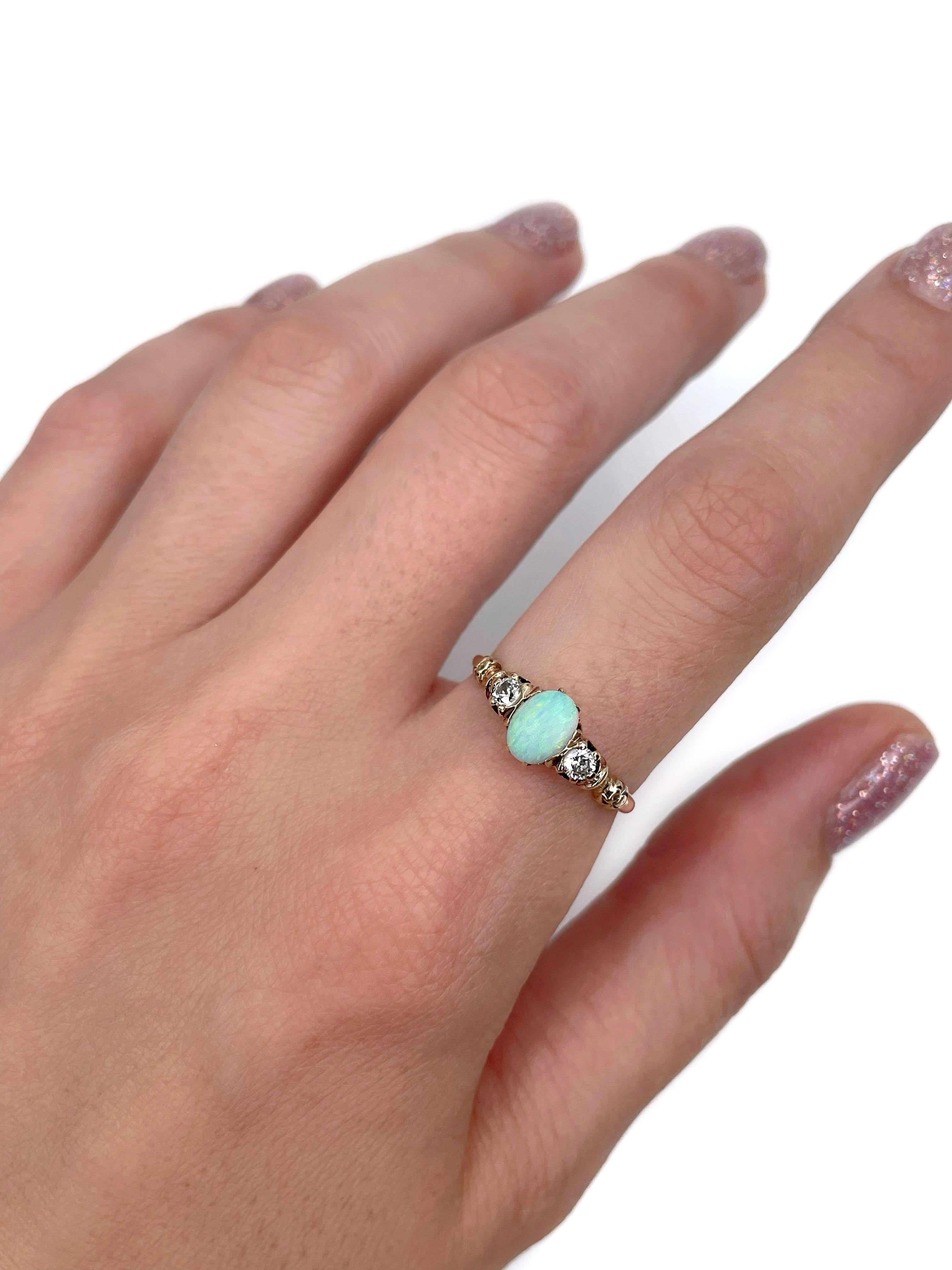 This is an Edwardian three stone band ring crafted in 14K yellow gold. The piece features 1 oval shaped opal cabochon and 2 round cut diamonds. 

Weight: 2.22g 
Size: 17.25 (US 7)

IMPORTANT: please ask about the possibility to resize before