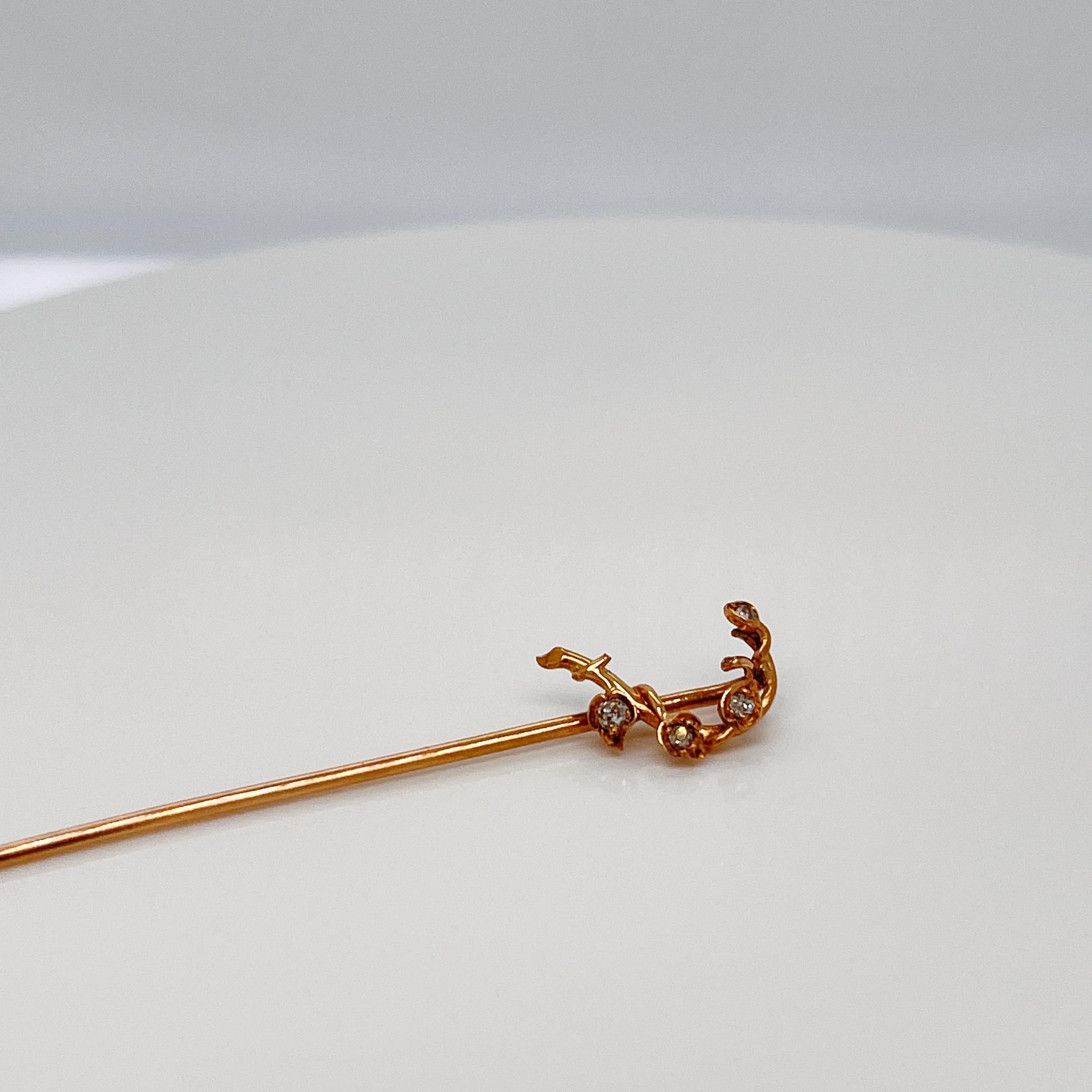 A very fine gold and diamond branch and vine stickpin.

With pave set diamonds in the of leaves of a vine that wraps around a 14k gold branch.

Simply a great stickpin!

Date:
19th Century

Overall Condition:
It is in overall good, as-pictured, used